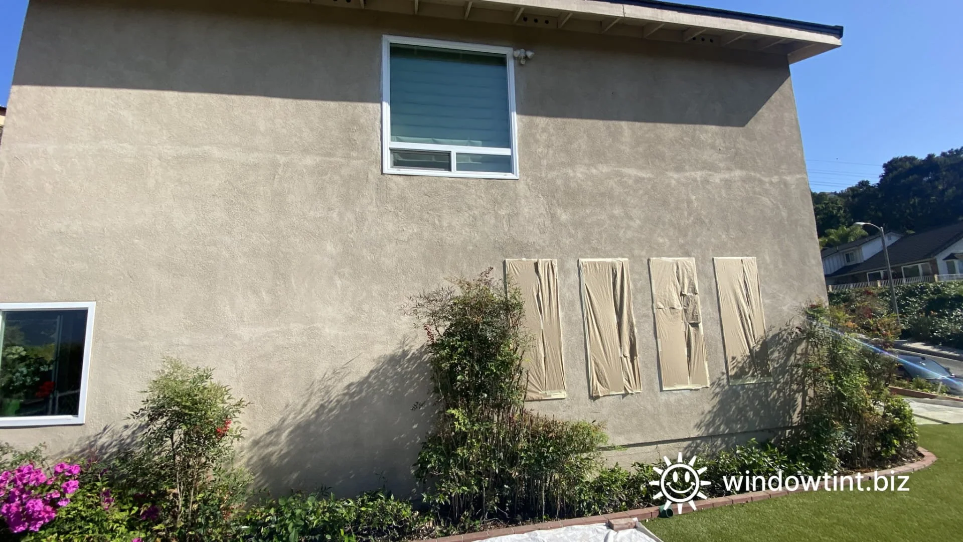 Artificial turf heat damage in Temecula CA caused by sun reflection off nearby home windows