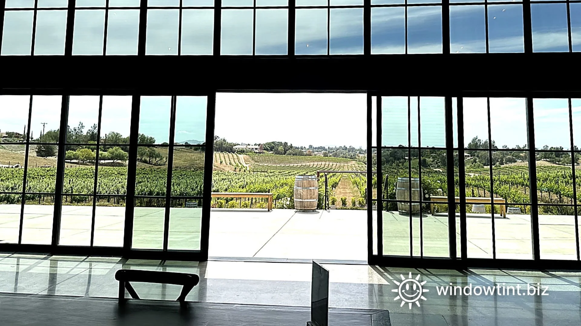 Solar control window film installed on large glass windows at a Temecula winery to reduce heat and improve interior comfort.