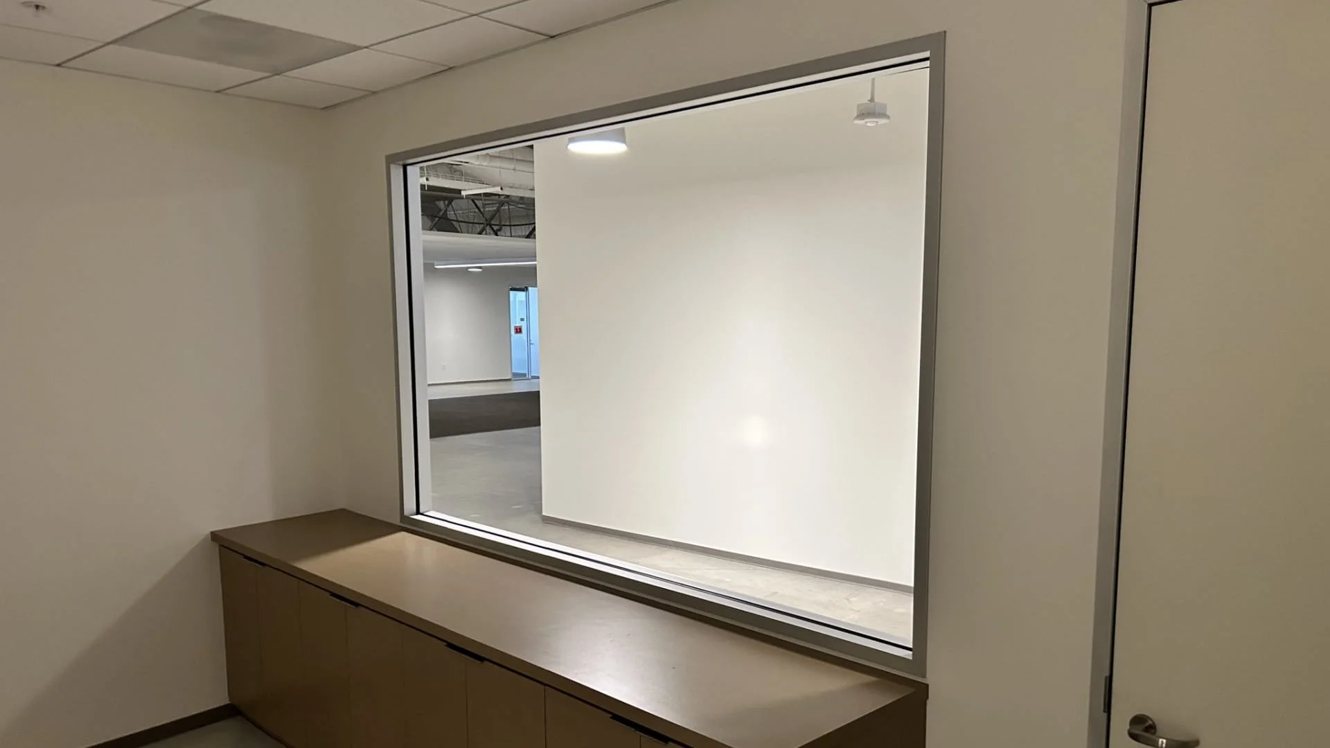 Frosted privacy film covering entire interior glass window to block visibility in studio workspace Glendale CA