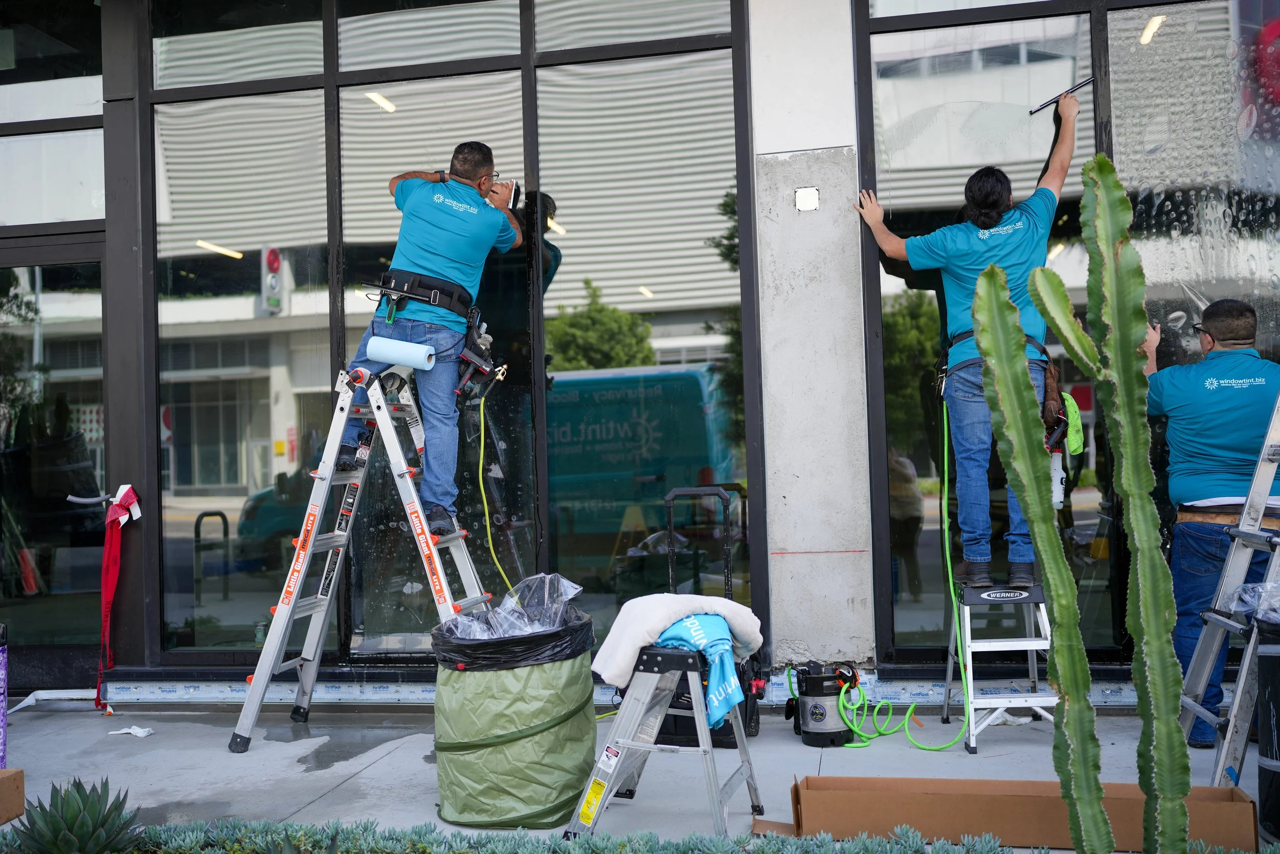 Applying anti-graffiti window film to storefront glass to protect against scratches and vandalism in Los Angeles
