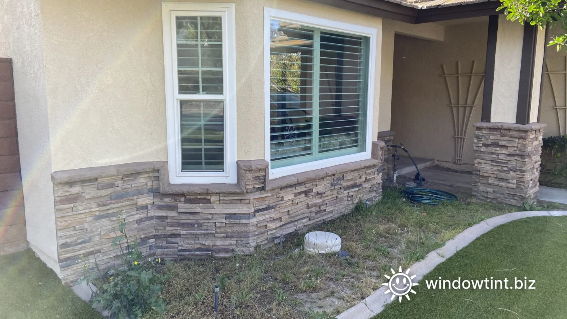 Residential window reflection creating a heat hot spot in a yard near artificial turf.