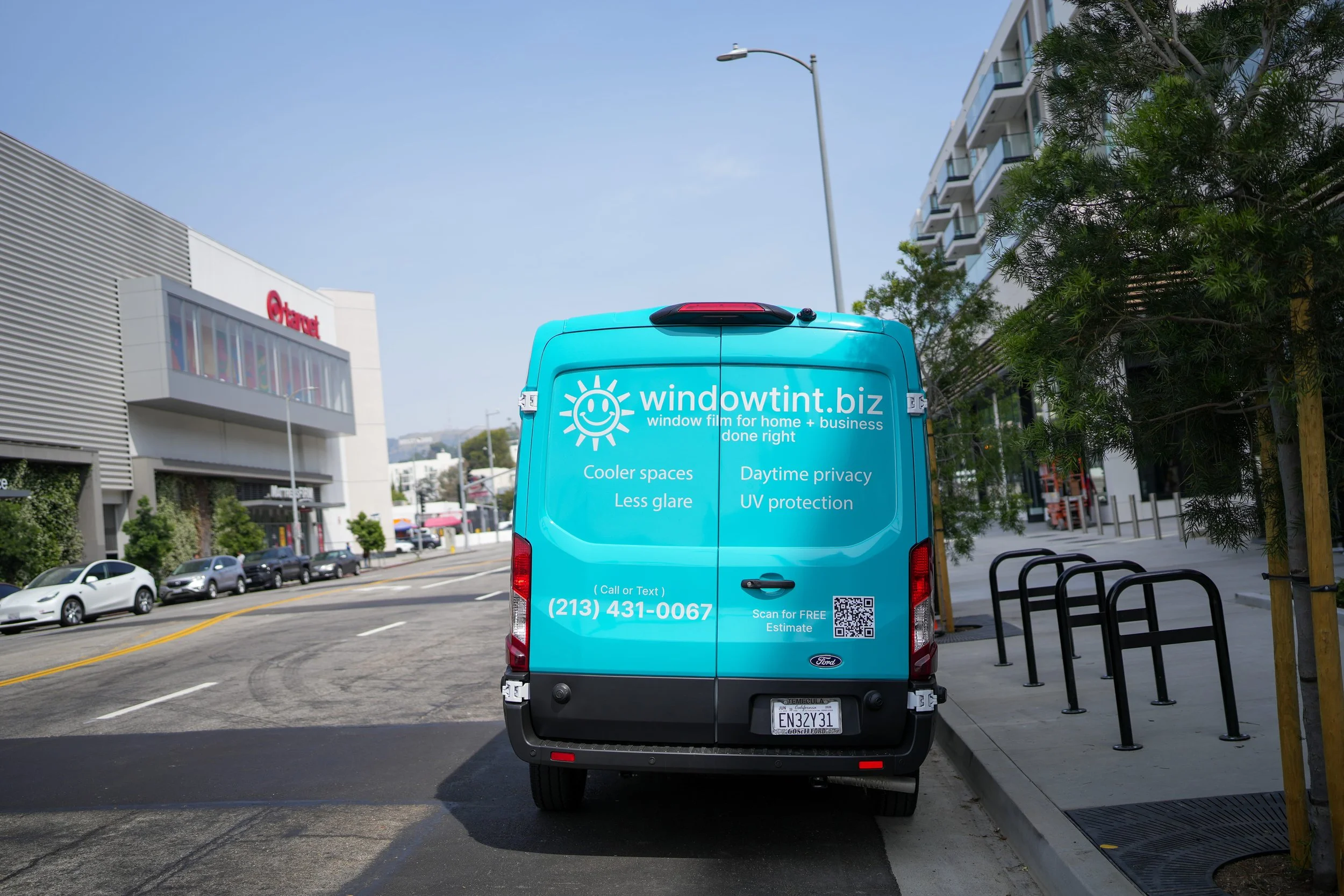 Window tinting service van parked outside retail location for storefront glass protection in Los Angeles