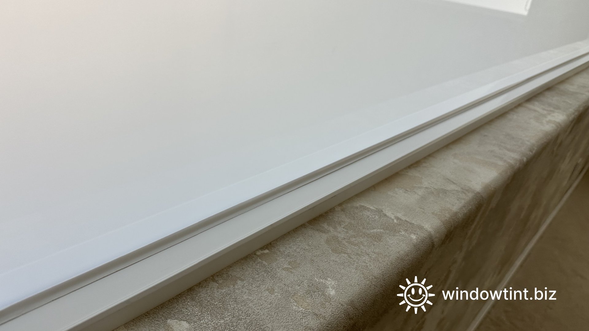 Close-up of switchable smart tint film installed on residential window glass for privacy control