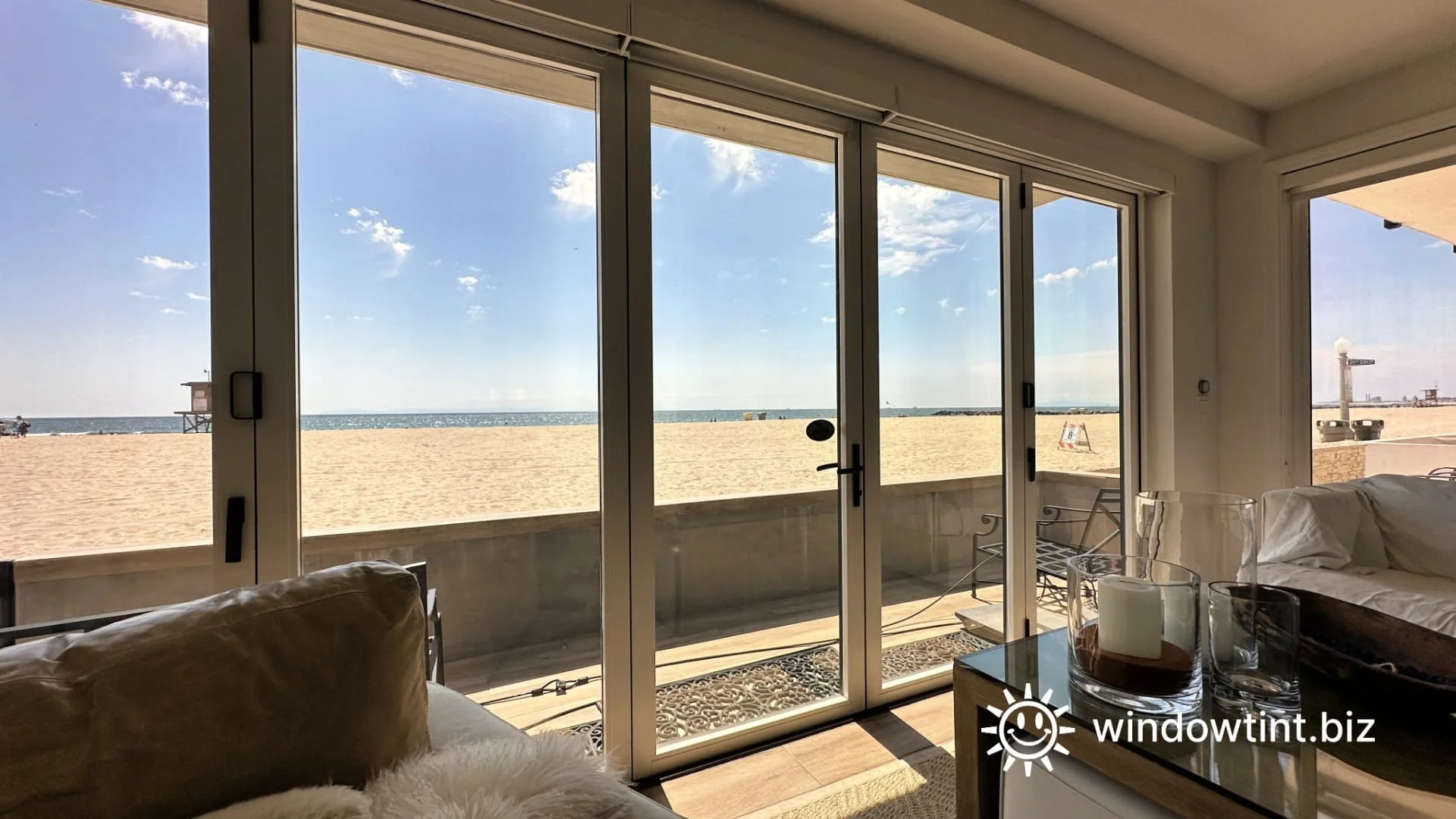Residential window film installed on oceanfront sliding glass doors in a coastal California home, reducing glare and heat while preserving the beach view.
