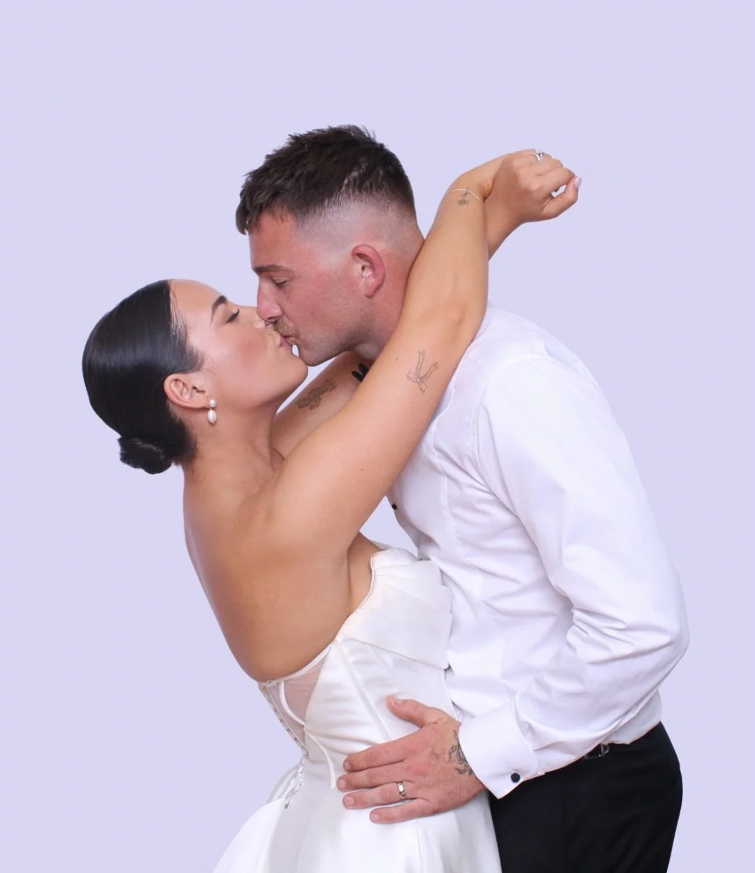 Bride and groom kissing in Fyre Photo Booth with white wedding backdrop at a Sydney wedding