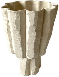 A concrete planter with a textured vertical ridged design.