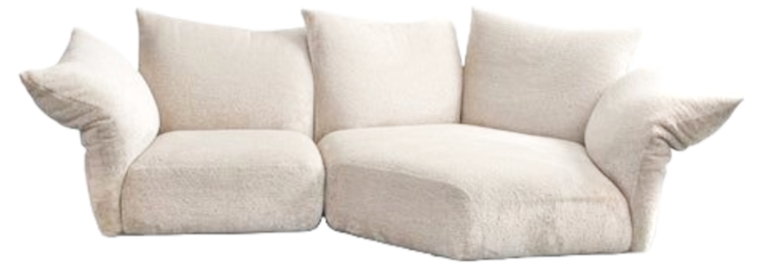 A plush, off-white, three-seater sofa with large, rounded armrests and cushions.