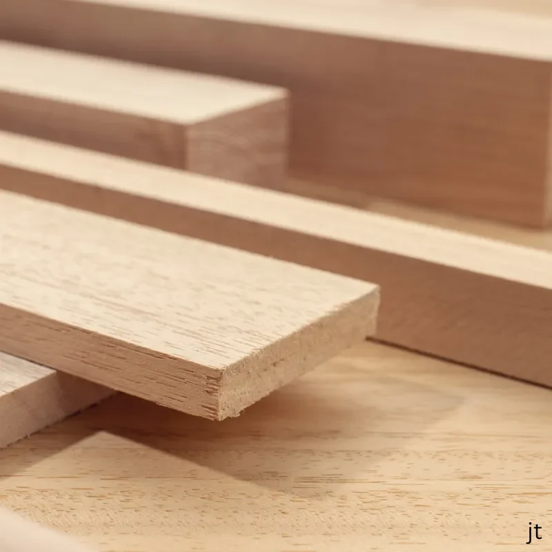 Close-up of light-colored wooden planks stacked on each other.