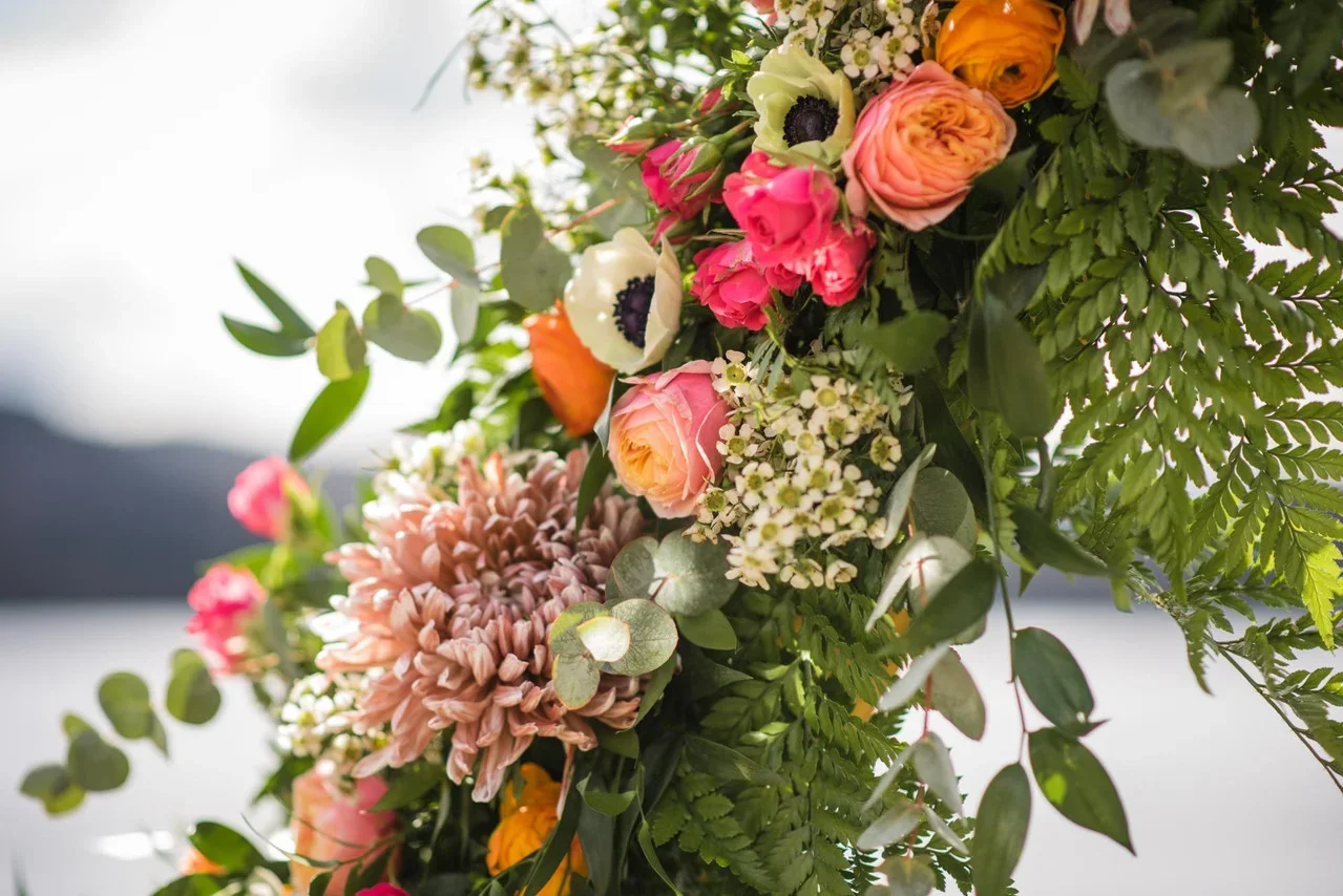 A colorful bouquet of various flowers and green foliage.