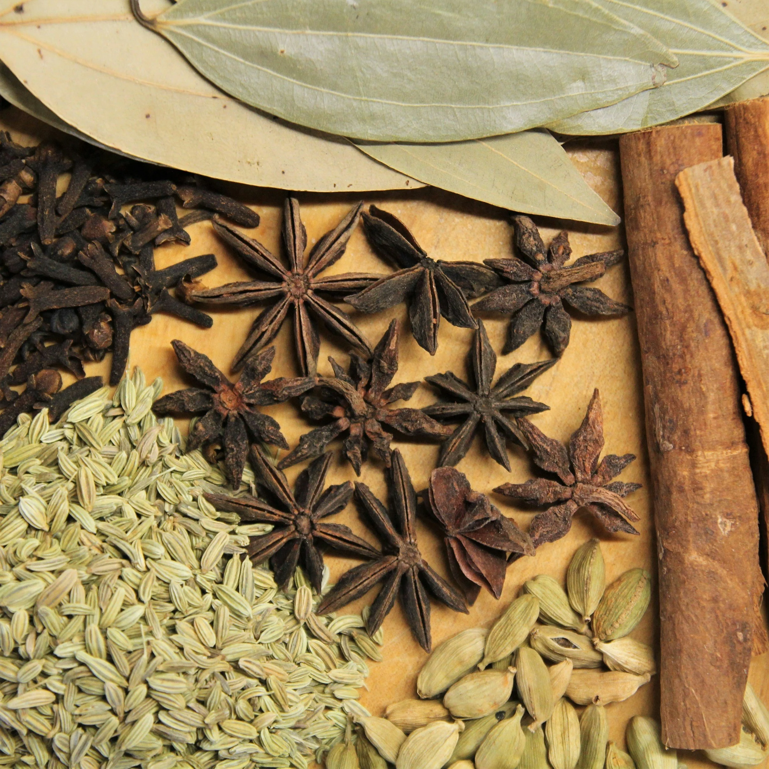 Assorted spice blend including star anise, cloves, cinnamon sticks, and other aromatic ingredients.