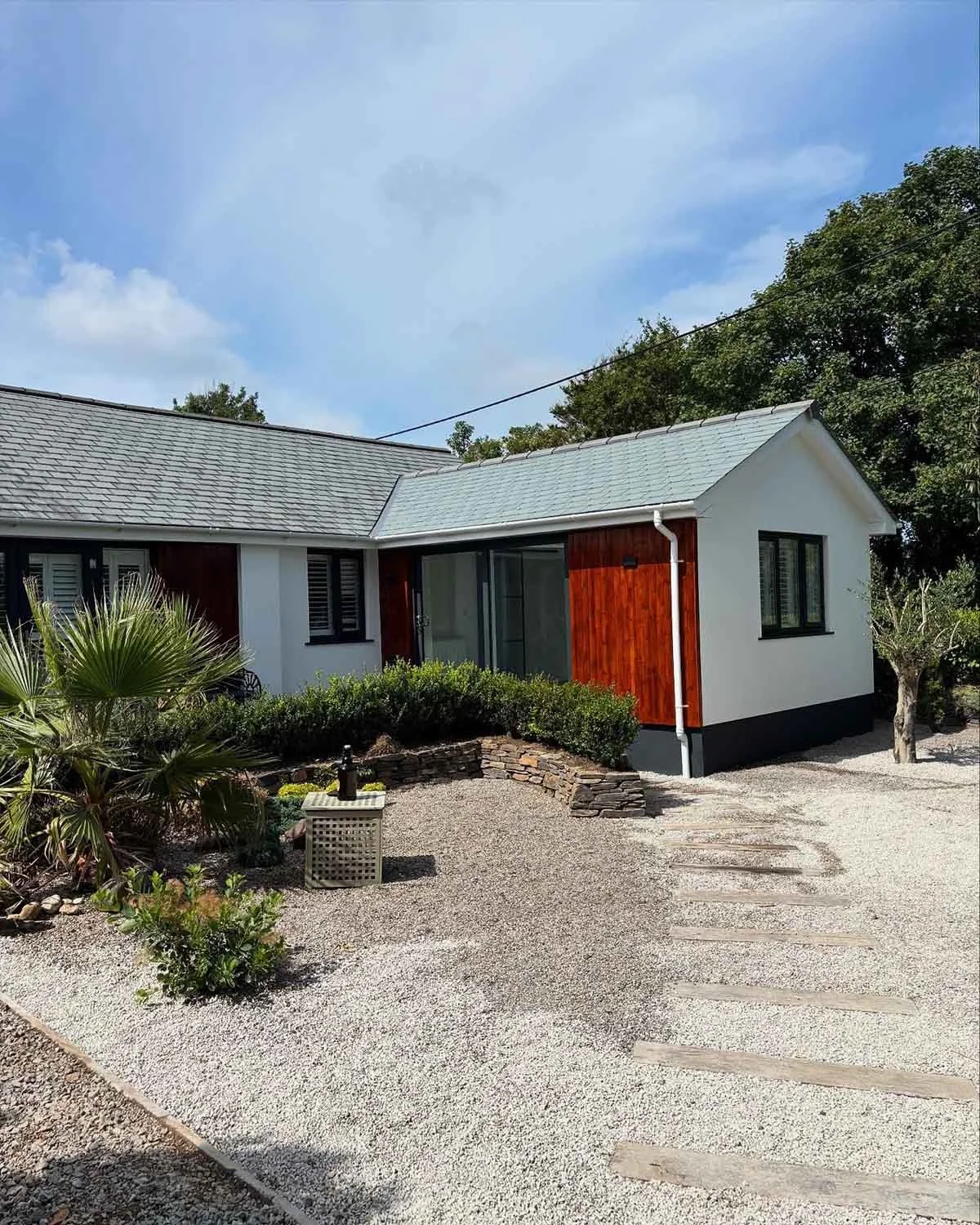 Modern extension with wood cladding and rendered walls and garden works linking to Building Projects Page