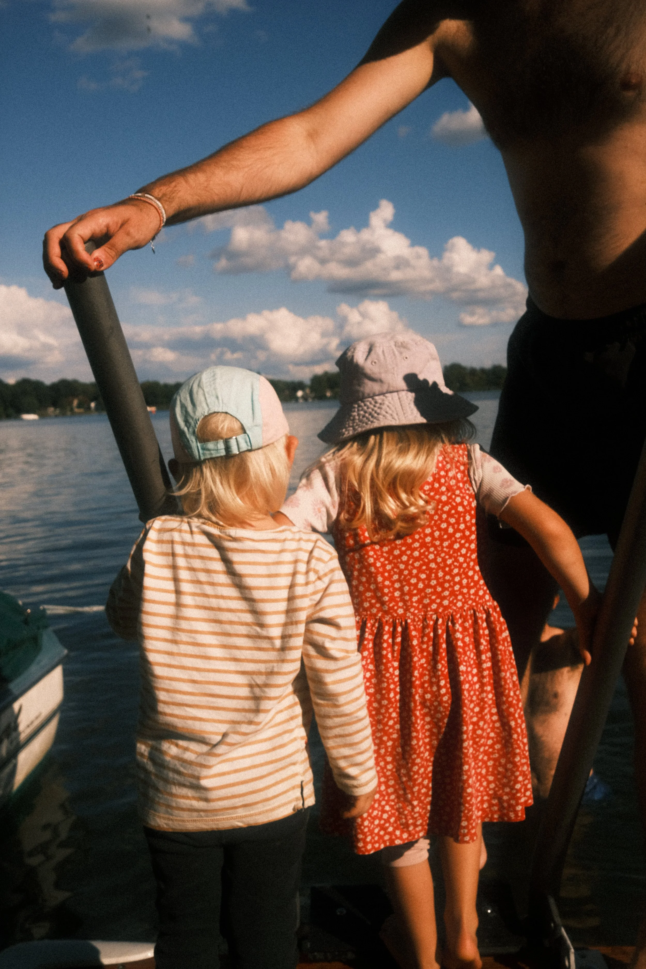 Zwei Kinder stehen am Wasser bei Sonnenschein – natürliche Familienfotografie voller Freiheit und Sommergefühl.