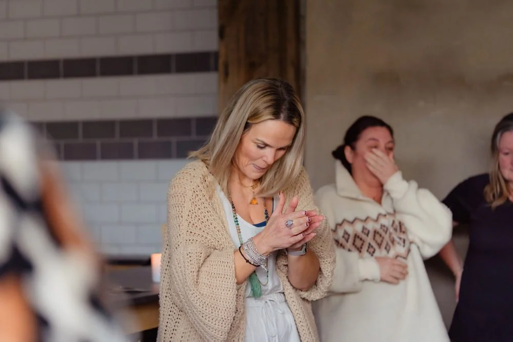 A yogi hosting a wellness retreat in South Wales, talking amongst a circle of people attending