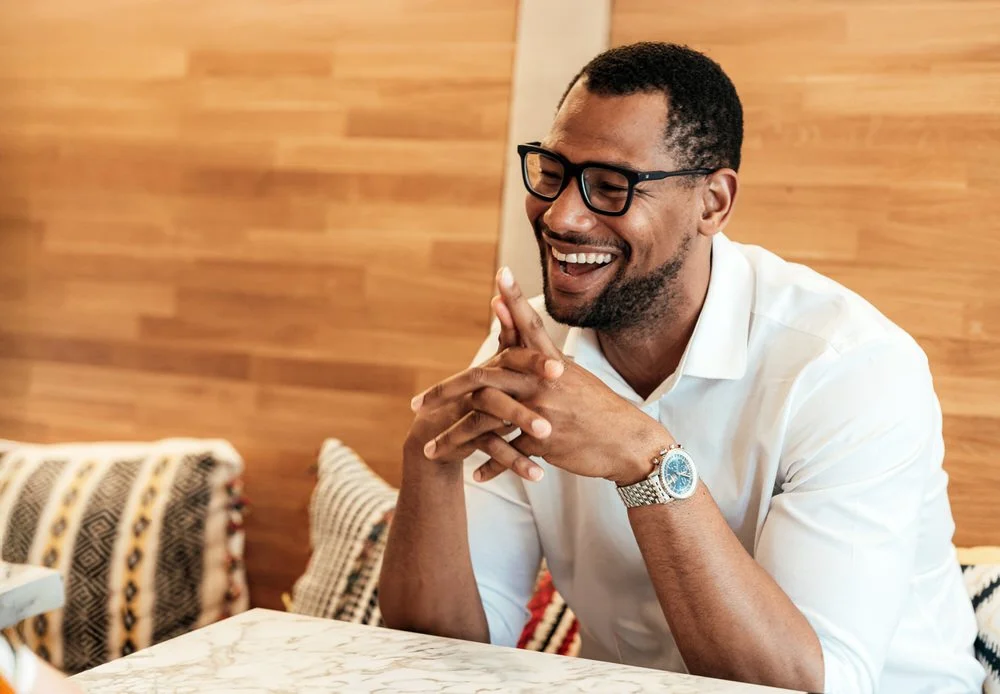 Businessman sat at a table having his commercial portrait taken at a restaurant in Swansea.