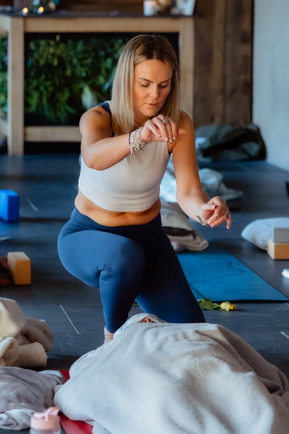 Yoga teacher Kelly Morgan performing reiki at a yoga retreat in West Wales.