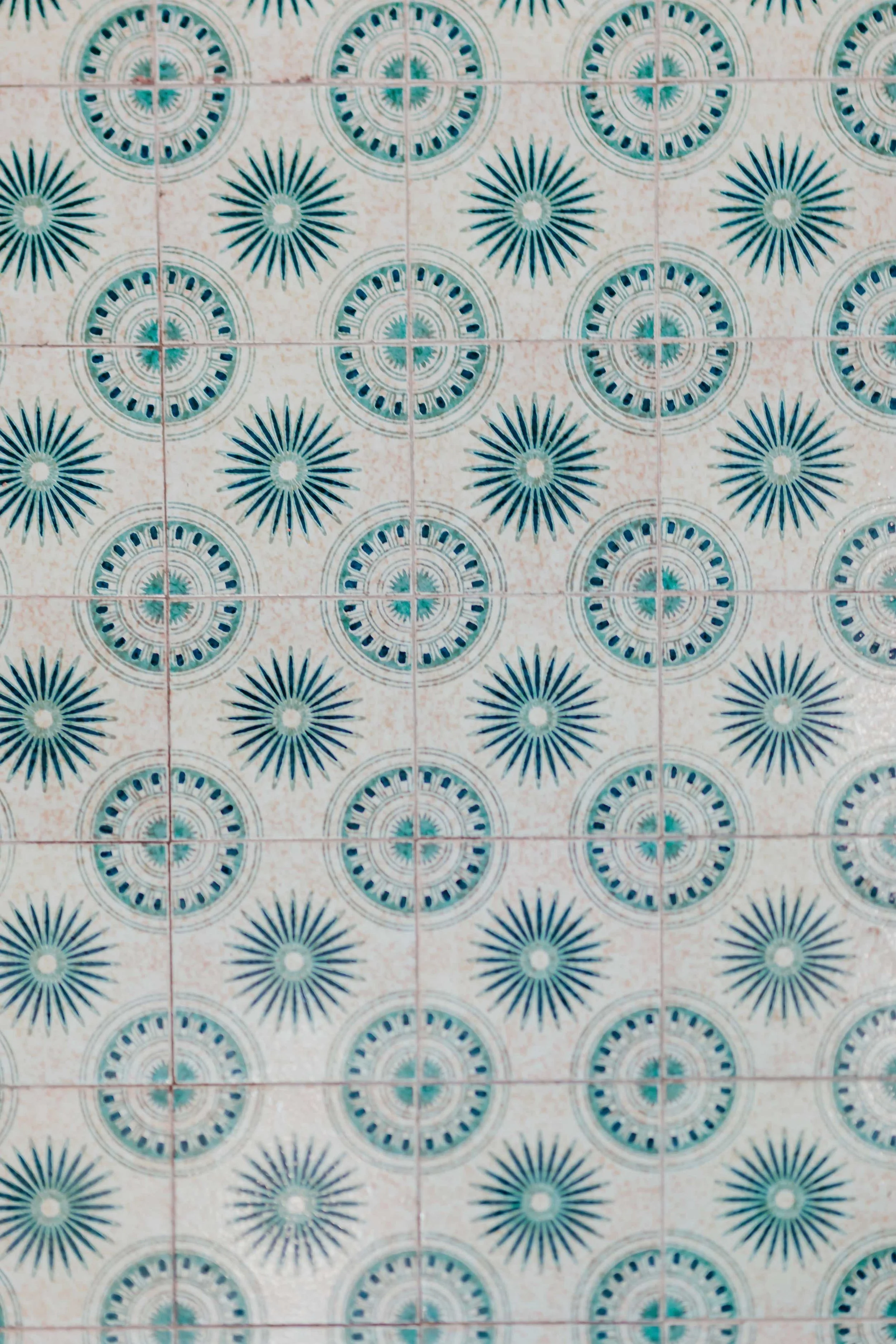 Patterned tiles with circular designs in shades of blue and white.