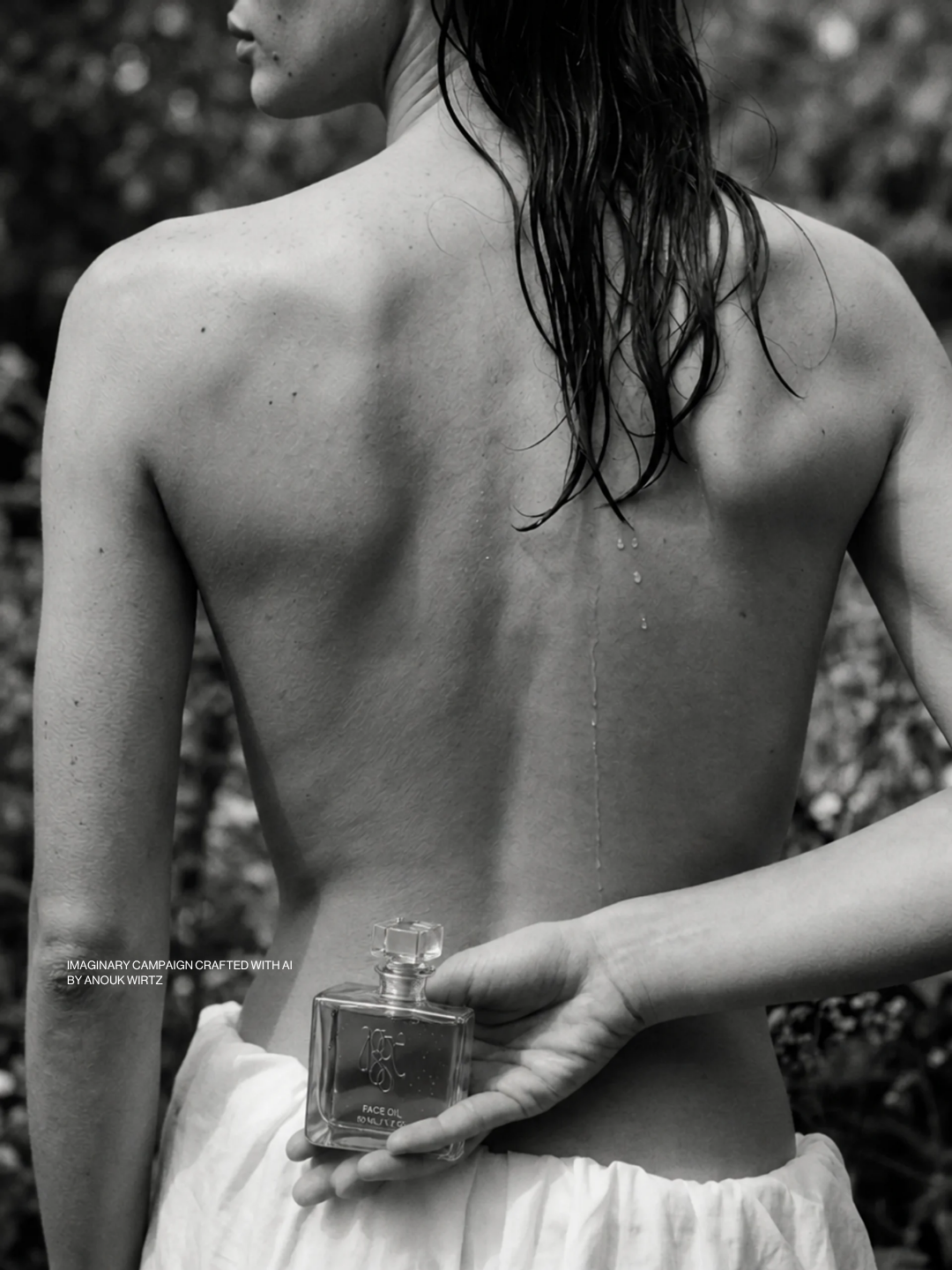 A black-and-white photo of a woman with wet hair holding a perfume bottle behind her back, standing outdoors.