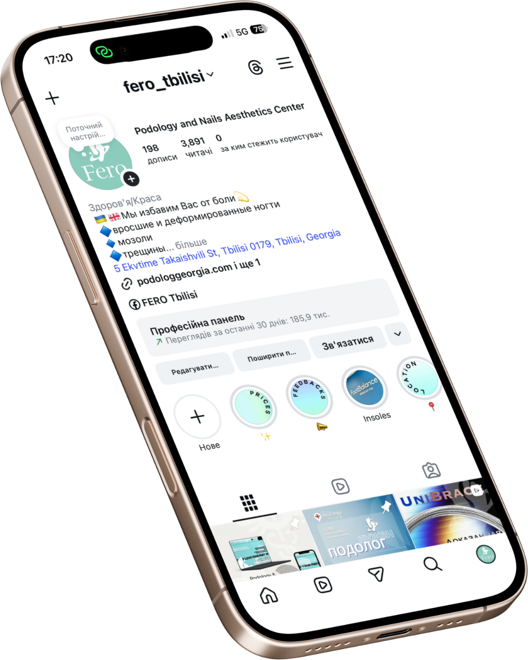 Close-up of a smartphone displaying an Instagram profile for 'fero_tbilisi,' a podology and nails aesthetics center, showing the page's posts, information, and contact details.
