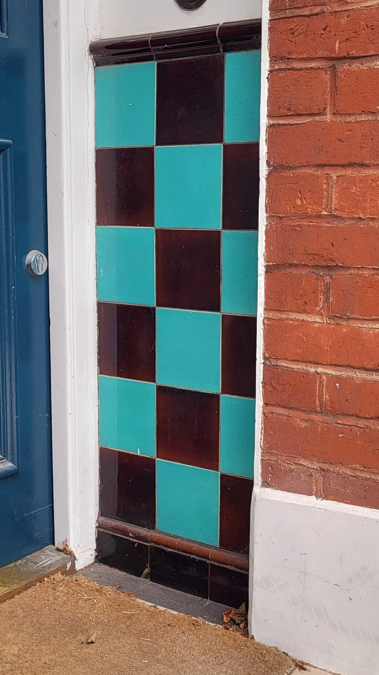 Plain glazed porch dado tiles in turquoise and brown chequerboard design
