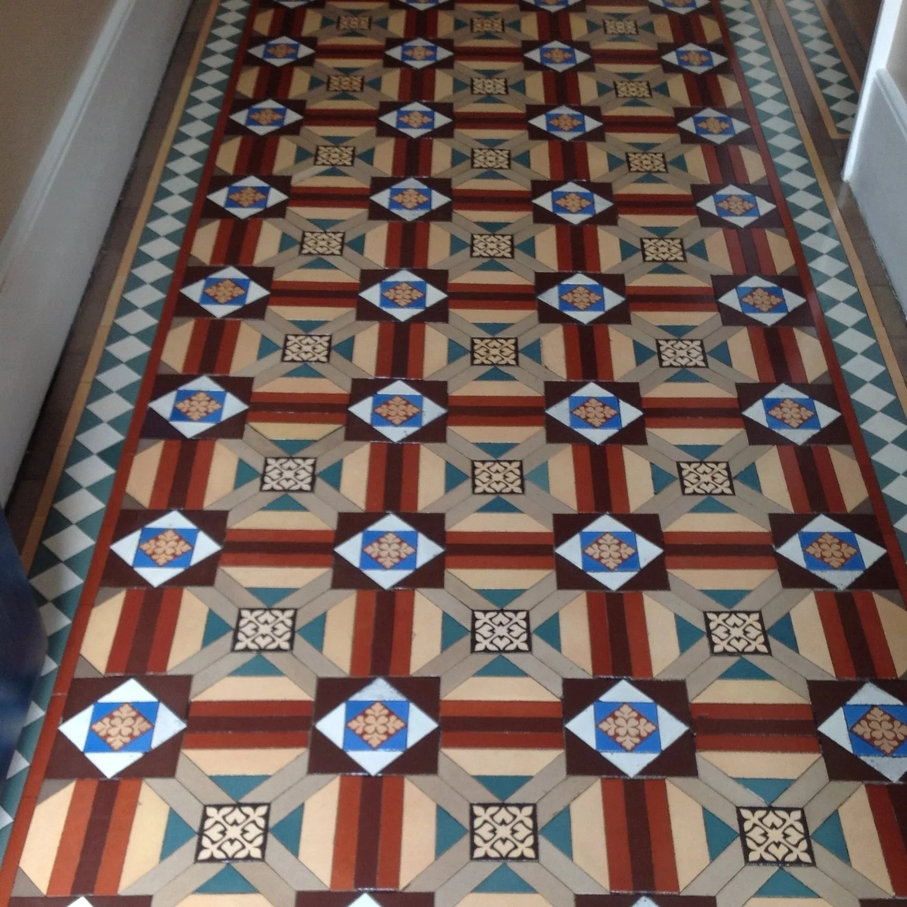 Colorful geometric patterned tile floor with border design