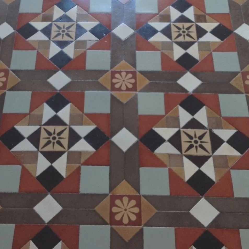 Patterned floor with two types of inlaid encaustic tiles and red and duck egg blue