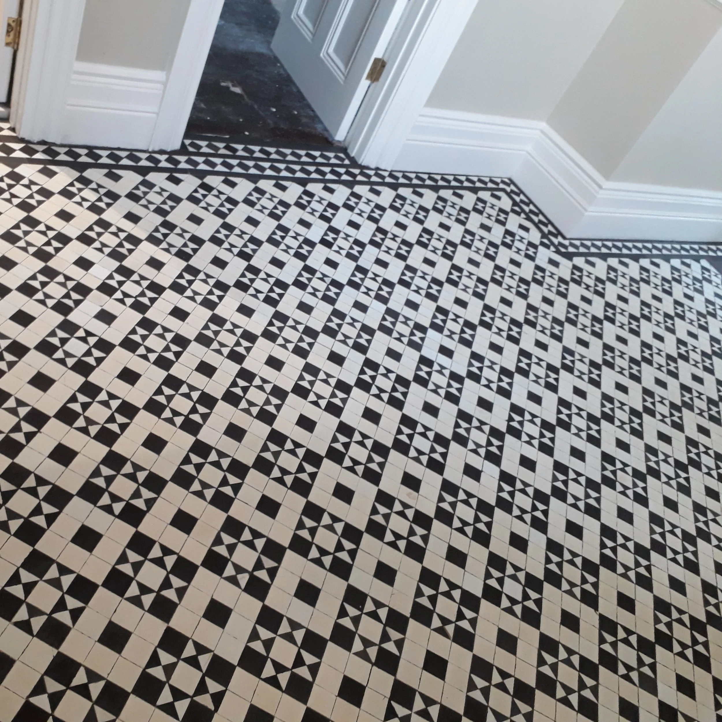 Same Black and white geometric pattern in a larger hallway but in a two inch format