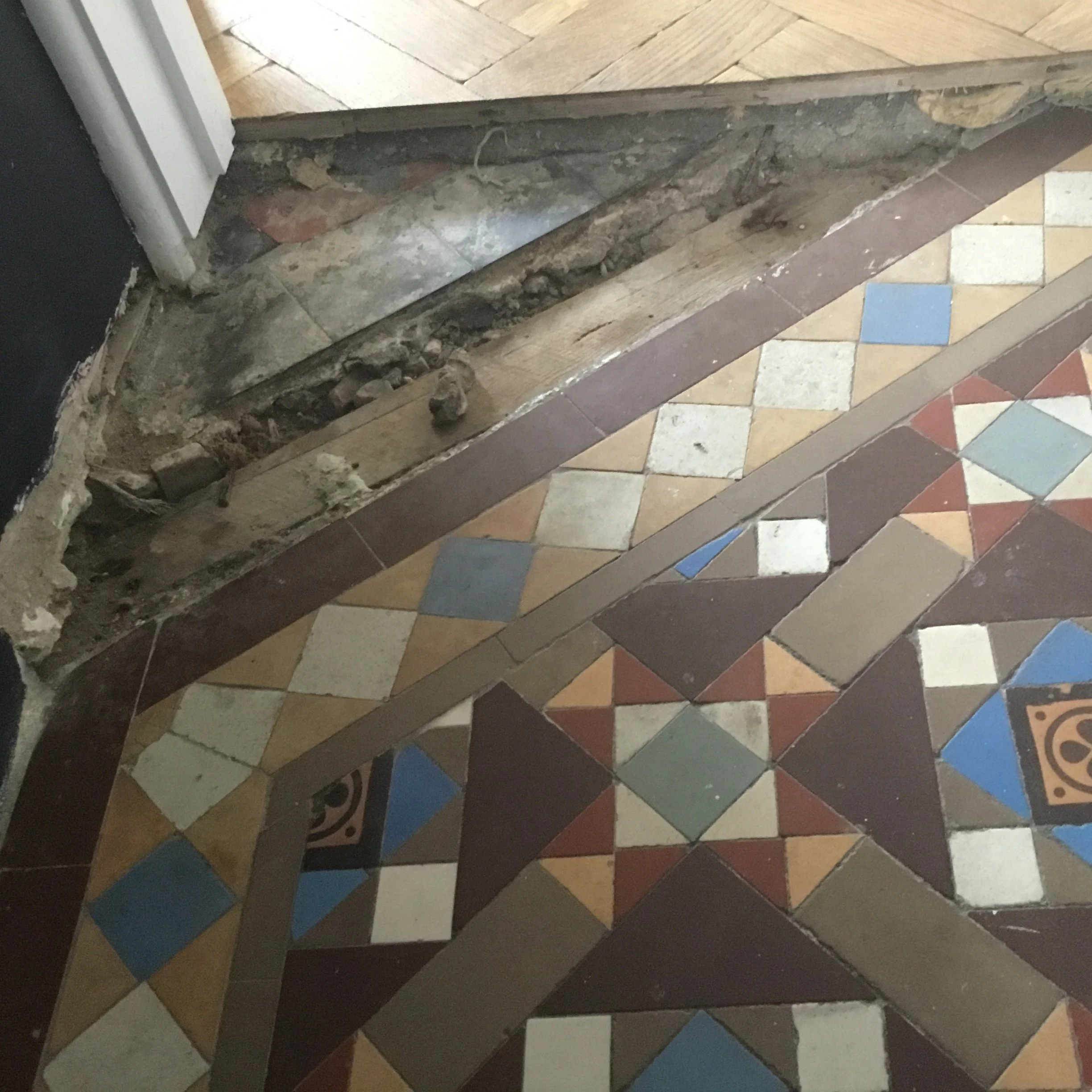 Hallway end with missing tiles on one corner