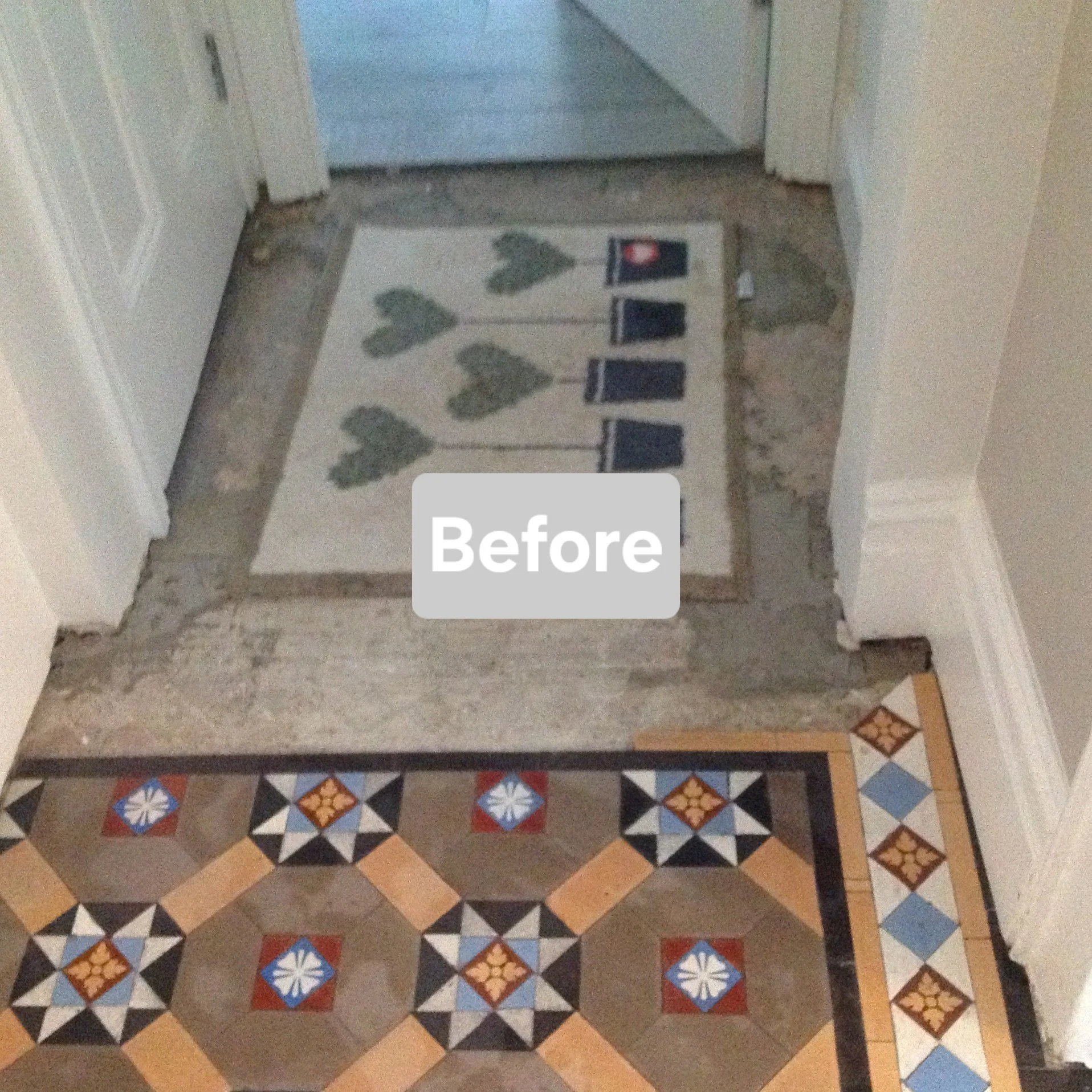 Before renovation, a doorway with a decorative tile floor, a rug with heart-shaped leaves, and a doorway leading to another room.