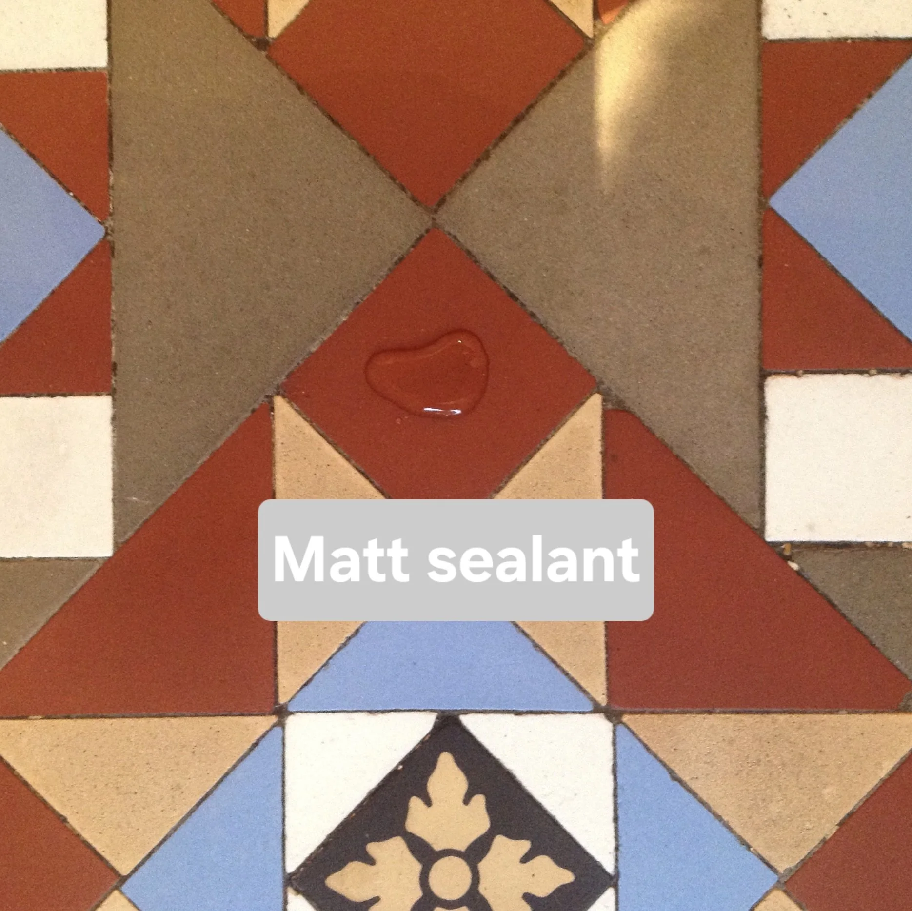 Colourful geometric tile floor with a domed water droplet on the surface and a label reading 'Matt sealant'.