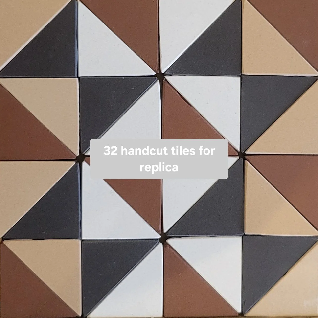 A set of 32 handcut geometric tiles in black, white, beige, and brown arranged in a pattern.