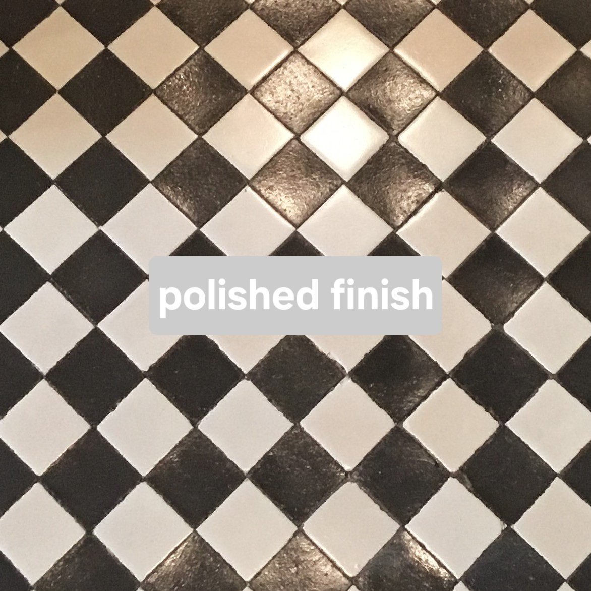 Close-up of a black and white checkered tiled floor with the text 'polished finish' overlaid.