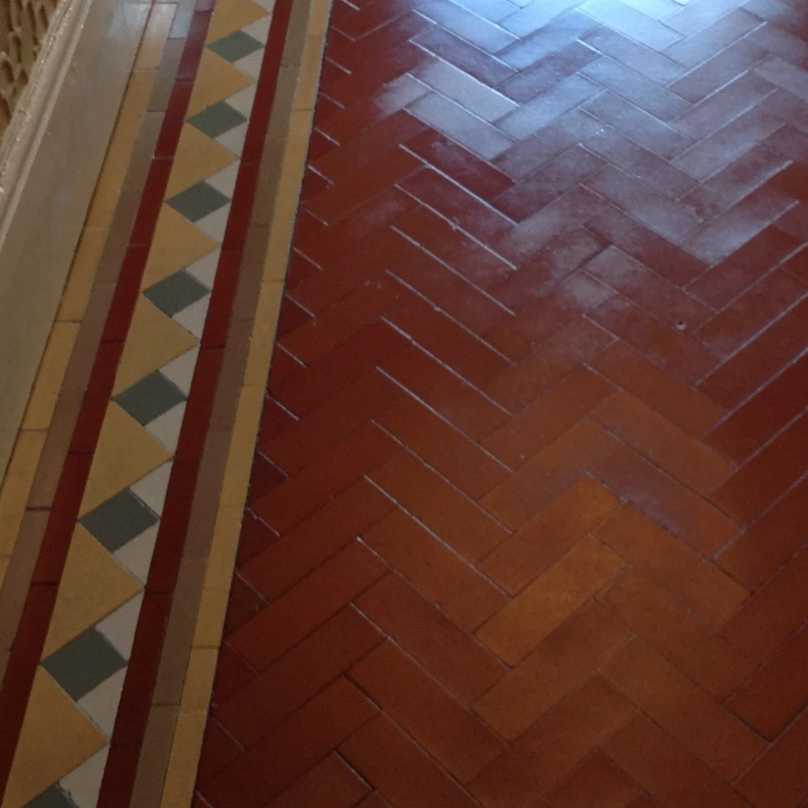 Close-up of an Edwardian herringbone tiled floor with a fairly typical Palladian border in yellow, white and blue