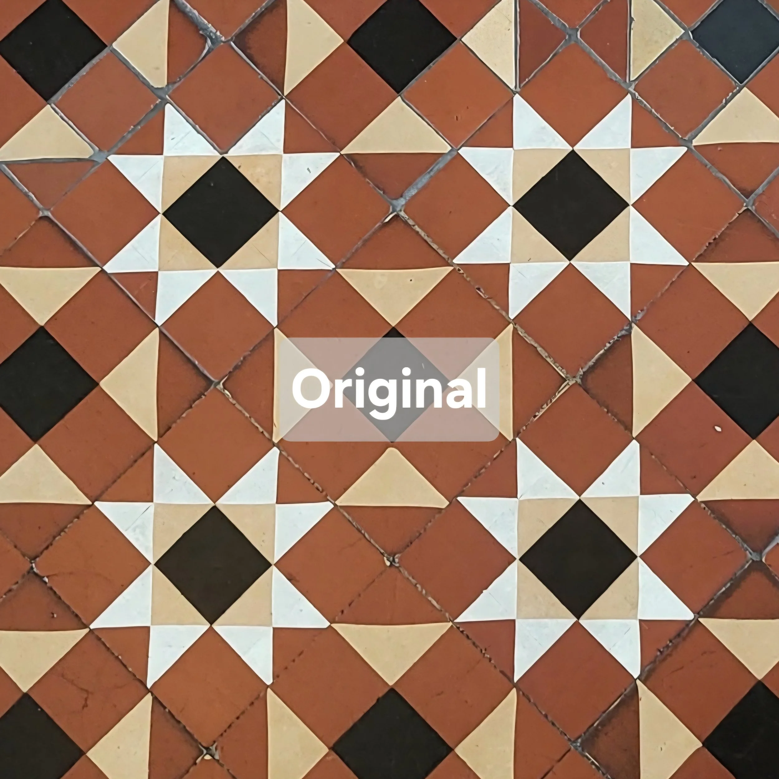 A tiled floor with a pattern of orange, cream, and black tiles arranged in a geometric design.