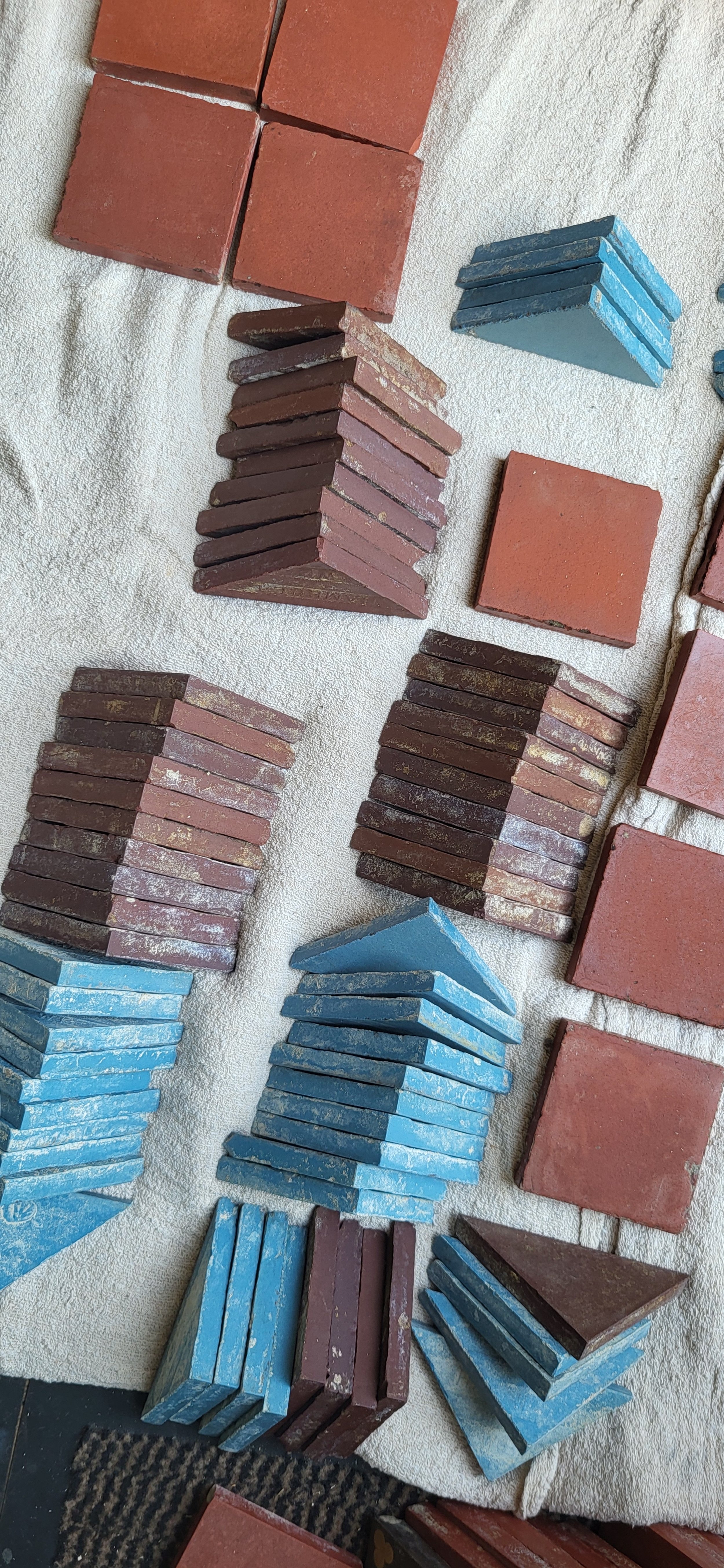 Various stacks of bricks in different colors including red, blue, purple, placed on a beige towel.