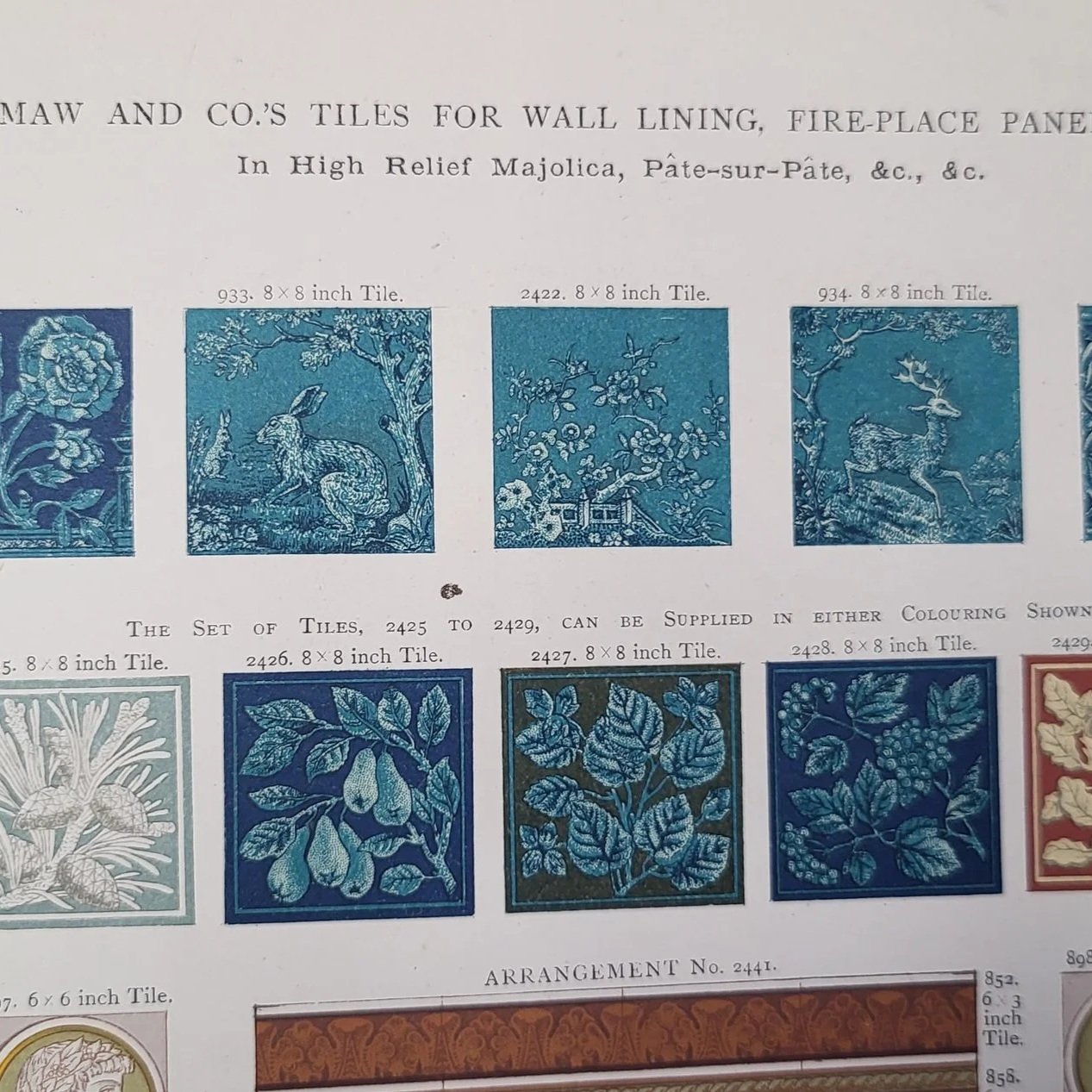 A page from a catalogue showcasing various blue decorative tiles with floral, animal, and nature motifs