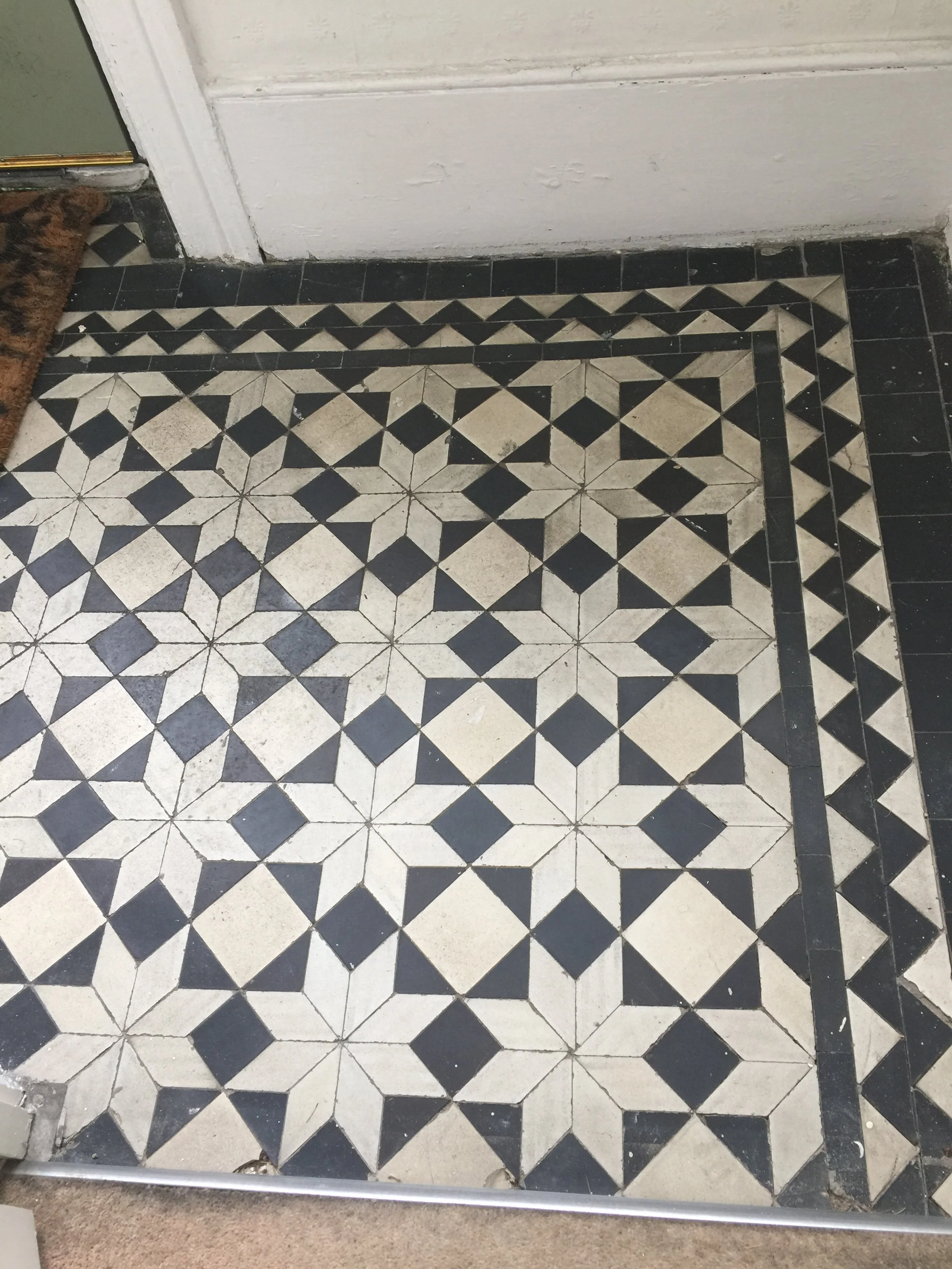 Minton tiles, Black and white patterned tile floor with diamonds forming an intricate design