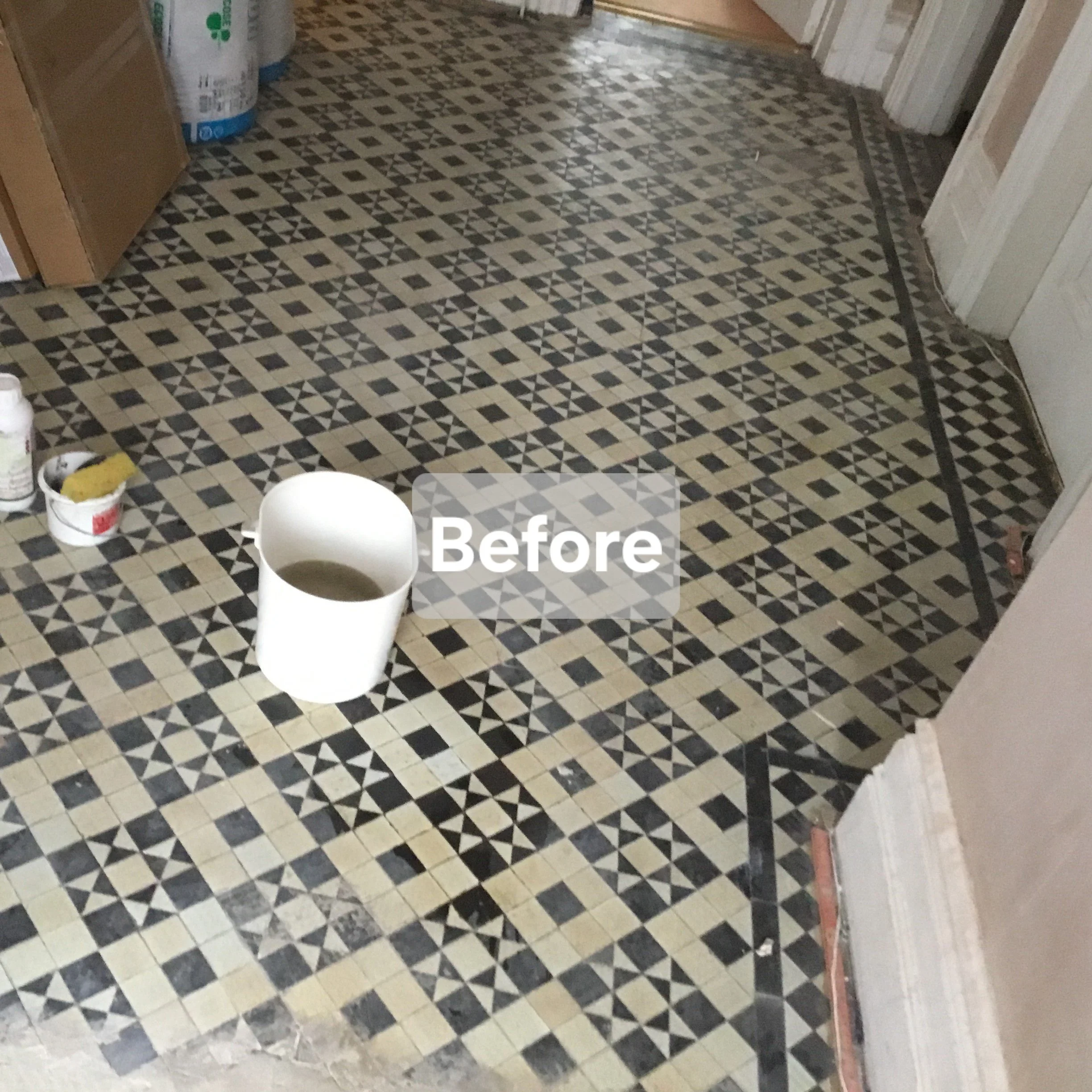 Interior of a room with black and beige patterned tile floor, construction supplies on the floor, and a label indicating this is a 'Before' image of a renovation project.