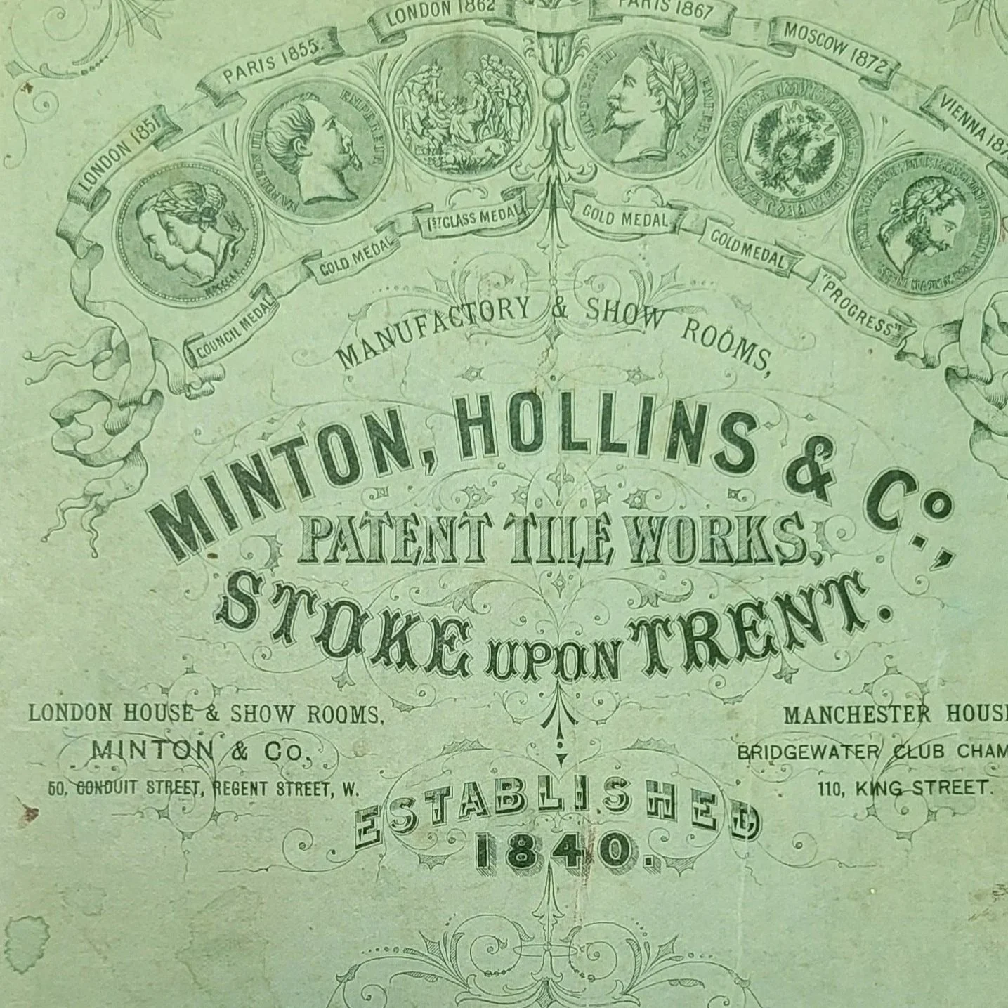 Vintage certificate or advertisement for Minton, Hollins & Co., Patent Tile Works, Stoke upon Trent. It mentions their history of awards and medals, including medals from Paris, London, Lyon, Moscow, Vienna, and other cities, with specific years. The company was established in 1840, located at 50 Conway Street, Regent Street, W., and their Manchester house at Bridgewater Club, with the London house at 110 King Street.