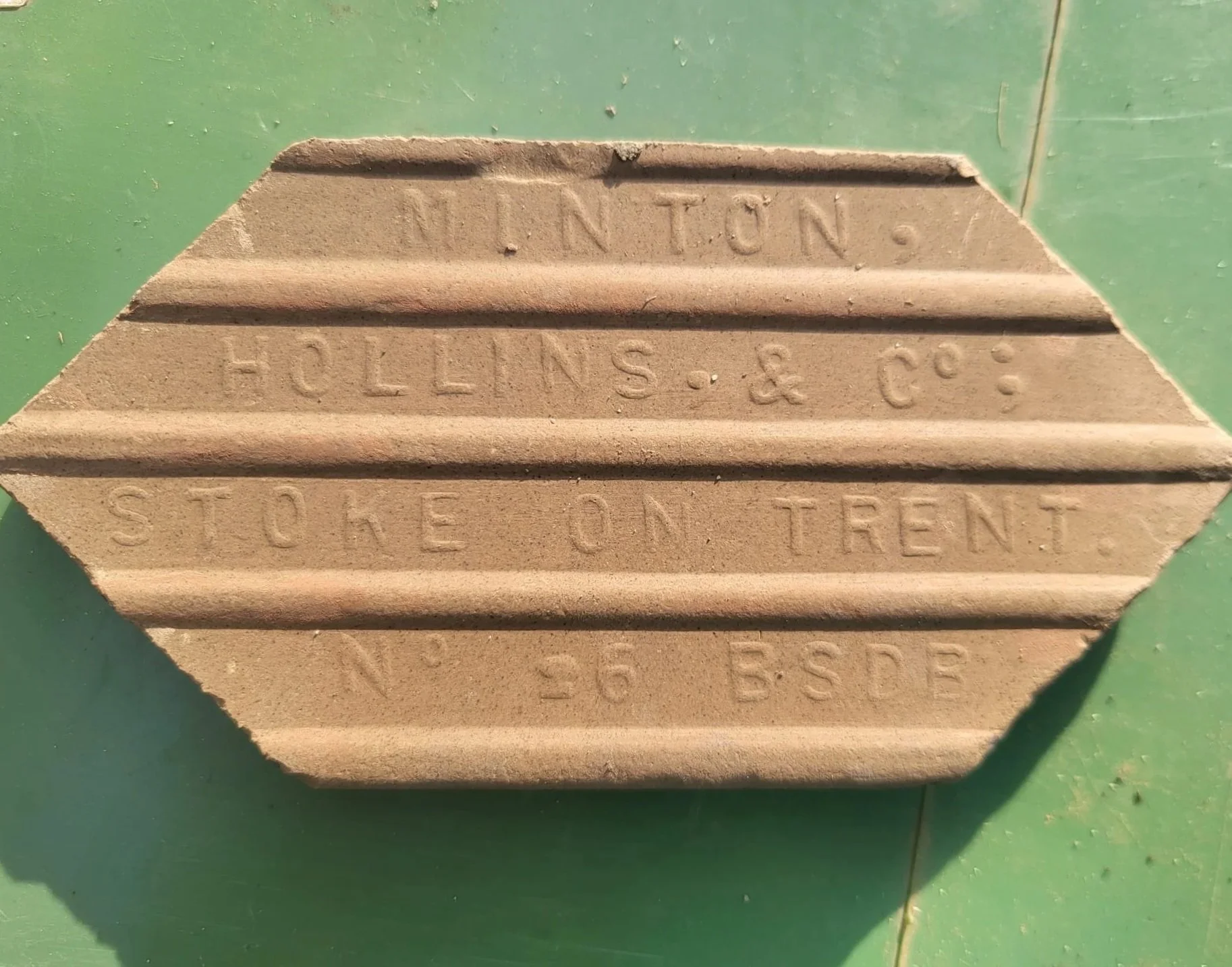 Close-up of the back of a tile manufactured by Minton Hollins in the Victorian era
