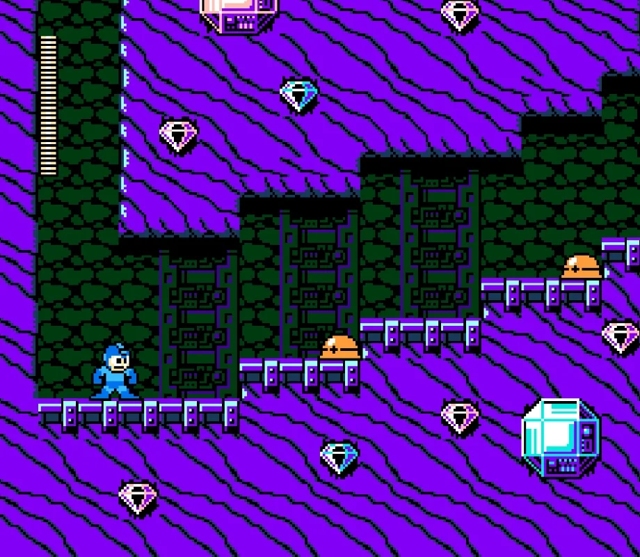 Mega Man 9 game screenshot. Mega Man is standing in an underground tunnel from the Jewel Man stage. Background is green and purple, there are diamonds trapped in the ground.