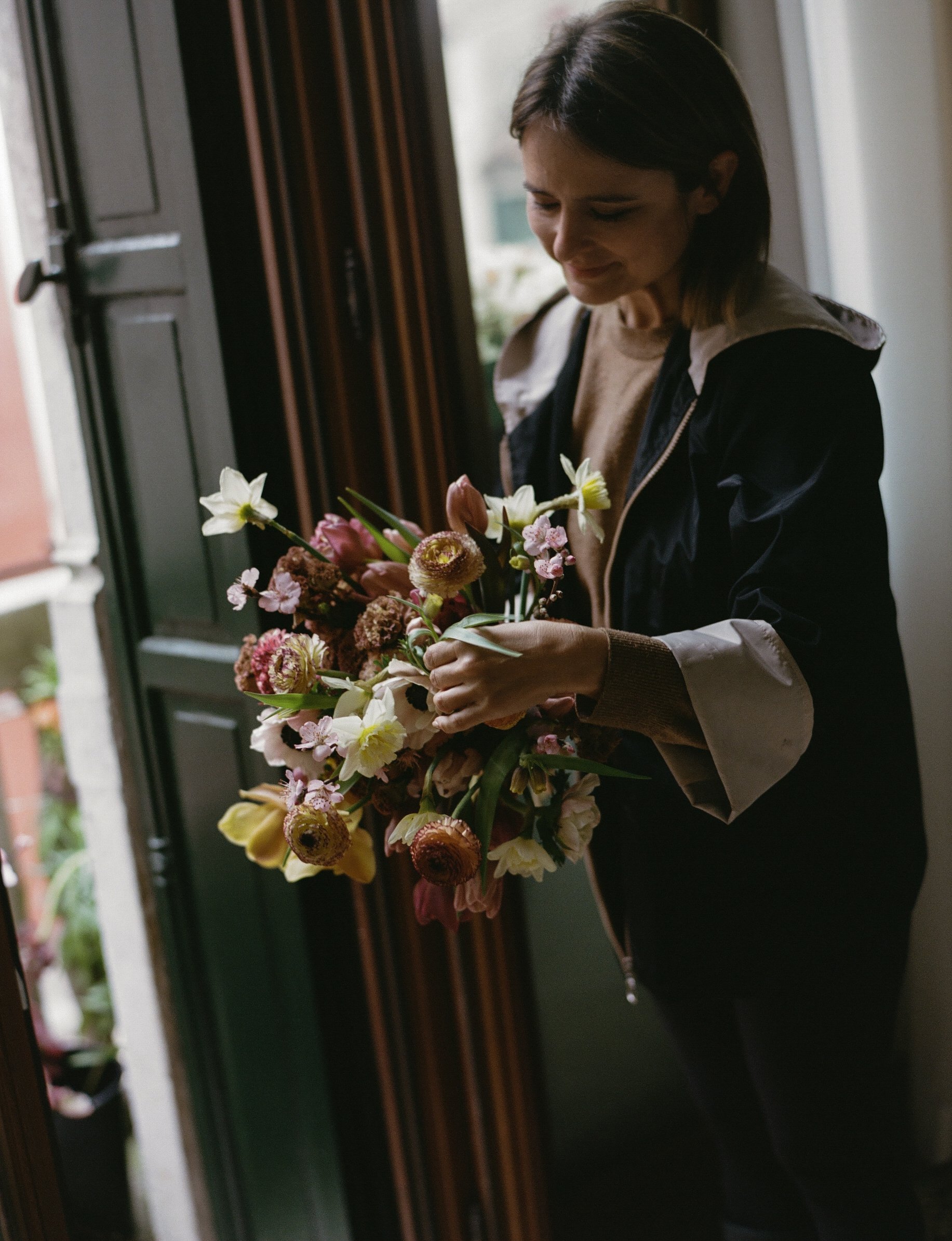 Florist finishing bridal bouquet with spring flowers in Venice, Italy