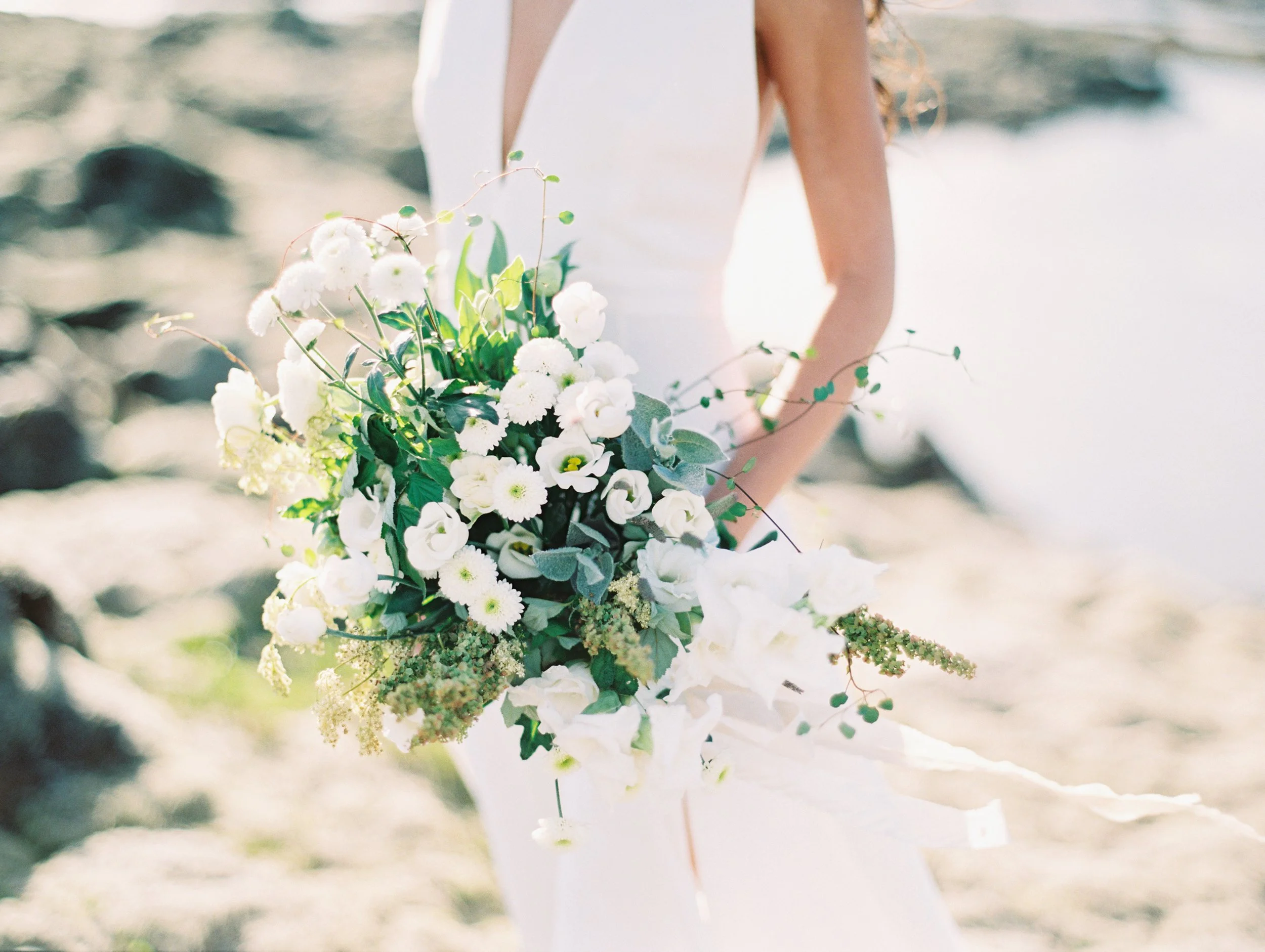 Iceland wedding bride holding a white and green bouquet