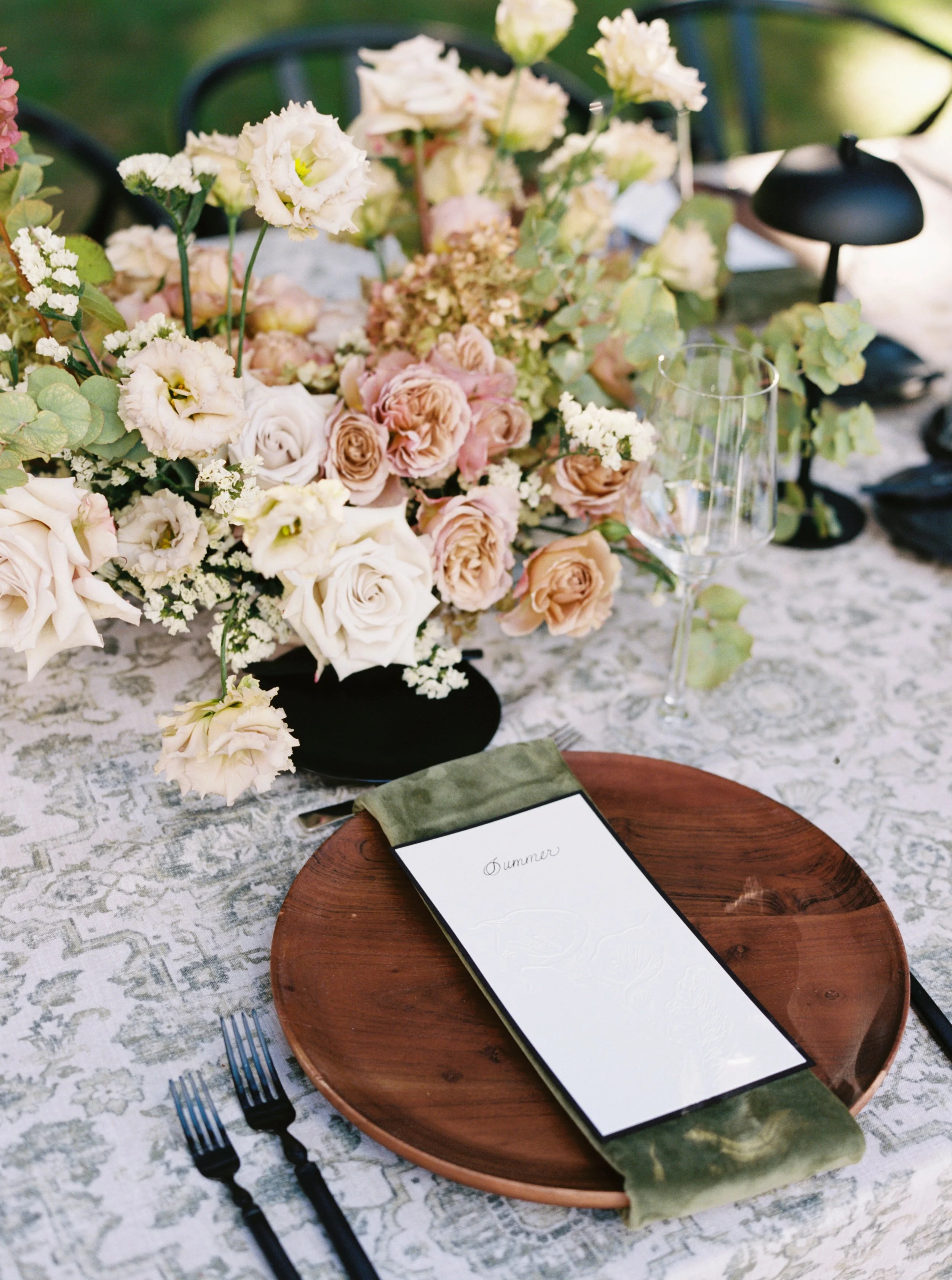 a lush floral centerpiece with garden roses and lisianthus wedding reception table