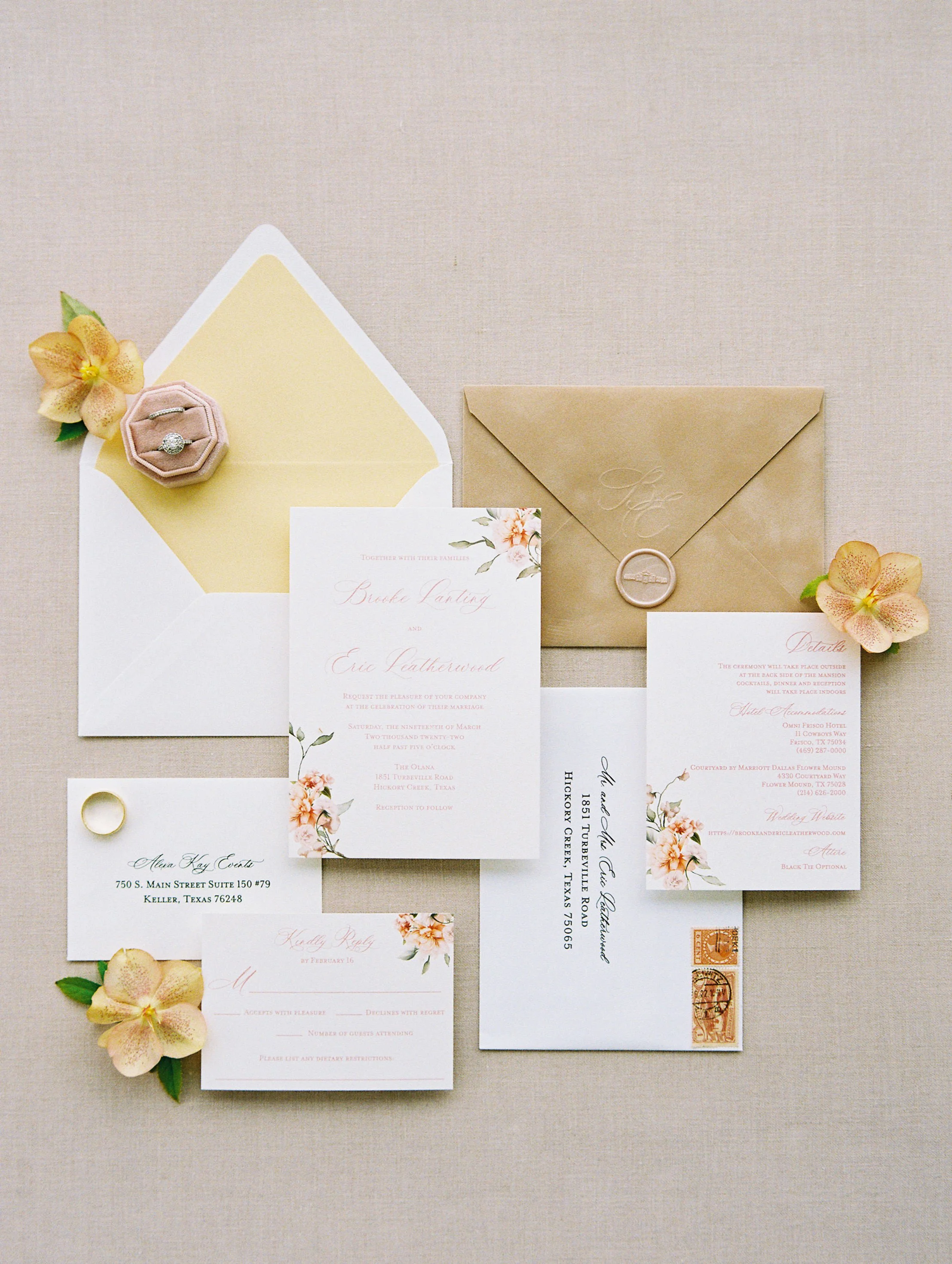 flatly of paper and envelopes with pops of flowers next to it