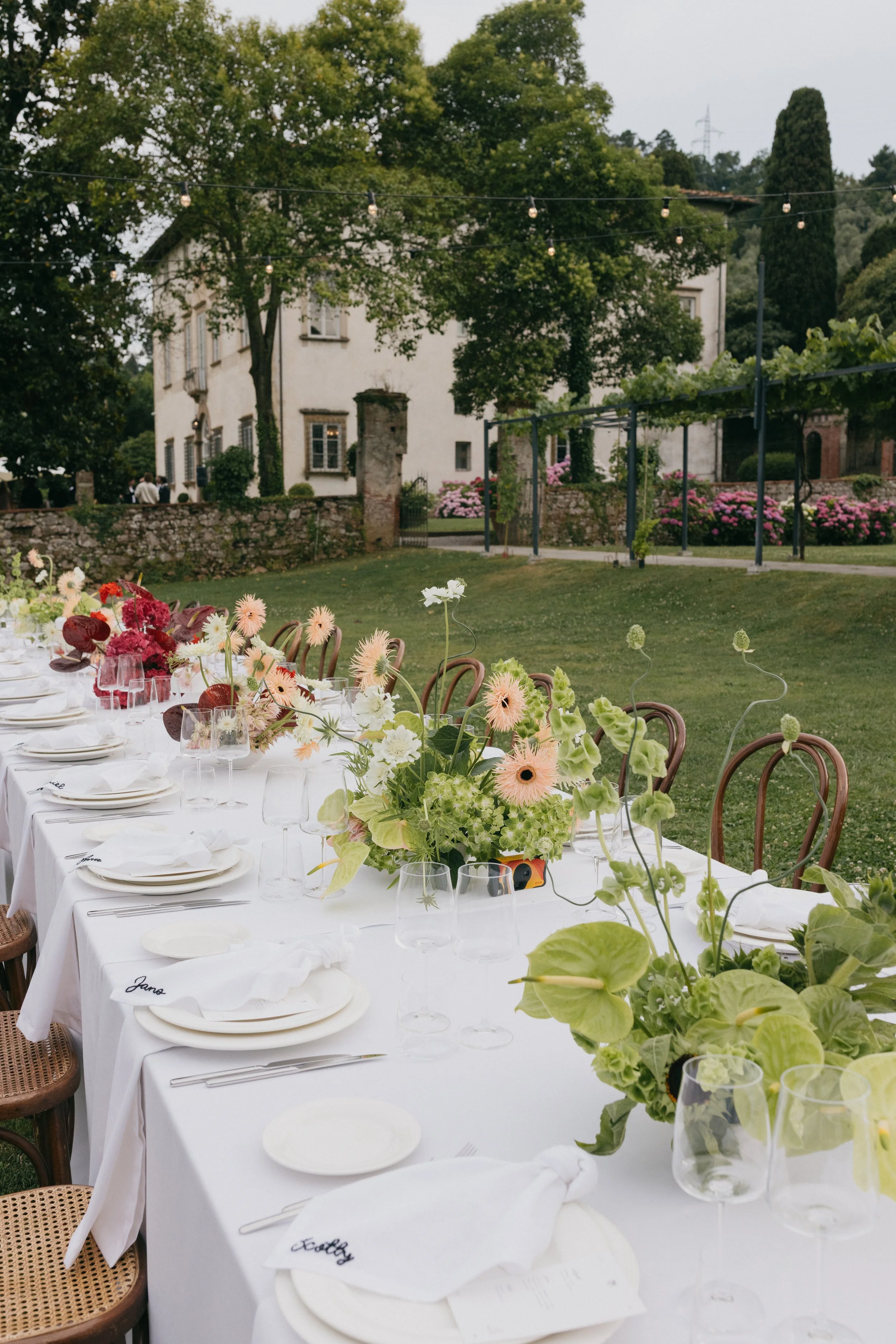 red and green table arrangements wedding reception Villa Buonvisi Tuscany
