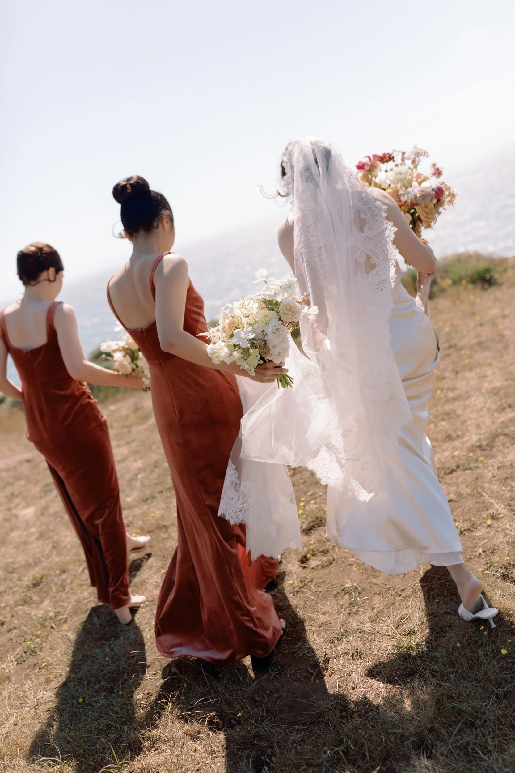 bride walking with bridesmaids at ceremony Timber Cove