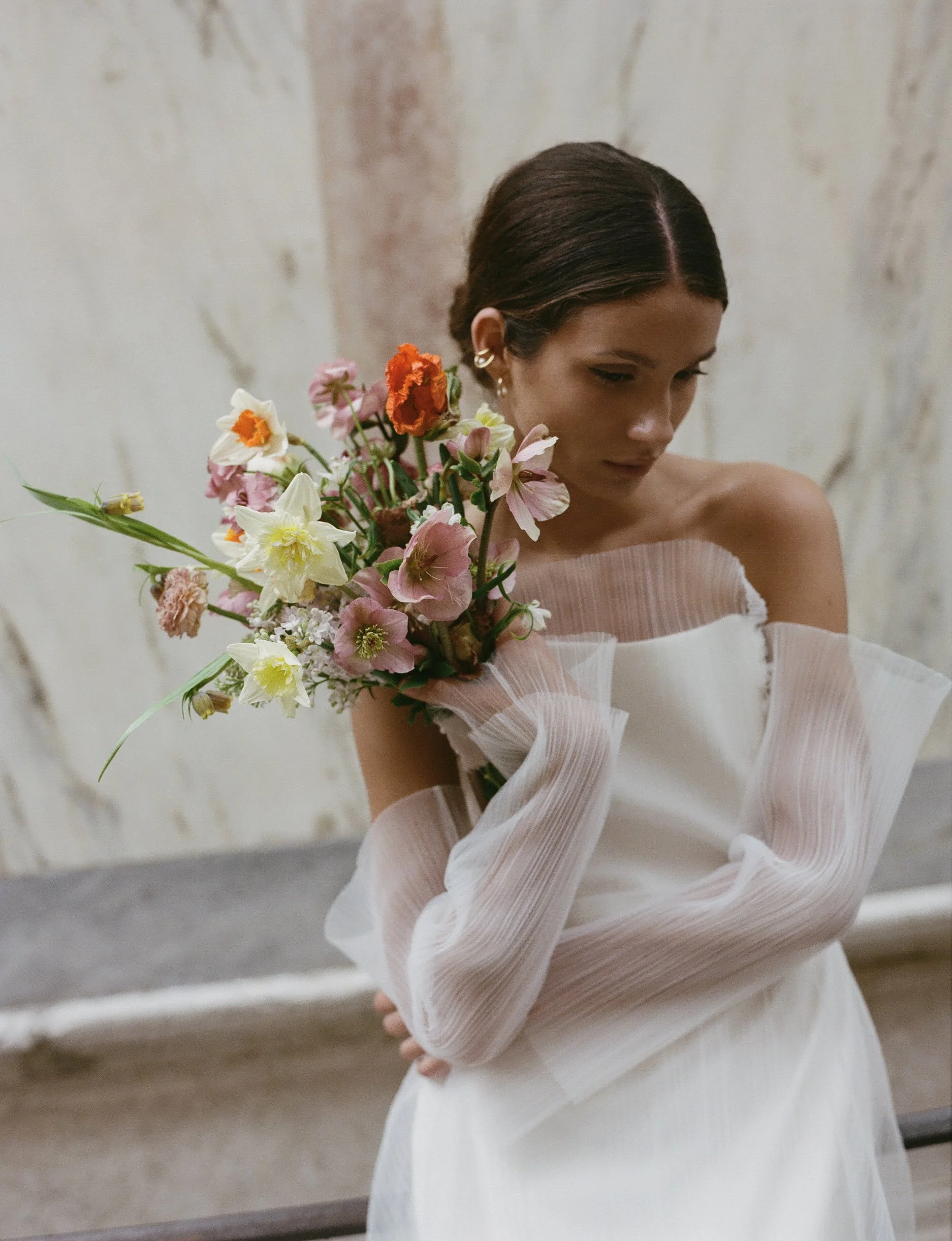 bride holding a bouquet of flowers in Venice St Mark's Square
