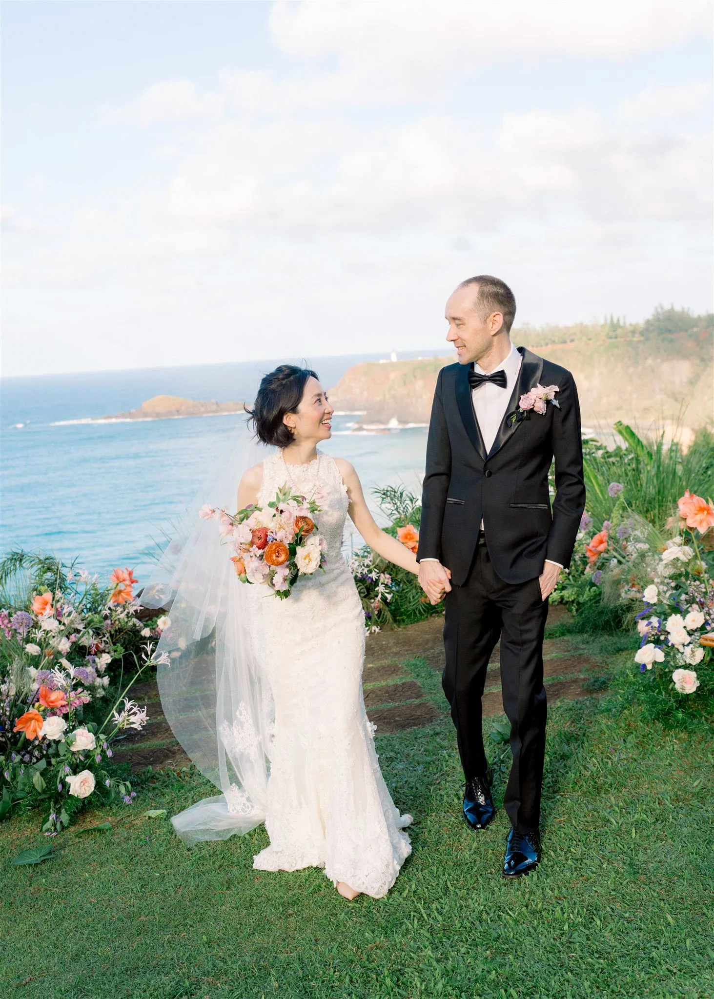 bride and groom with bouquet and ceremony flowers Kauai, Hawaii