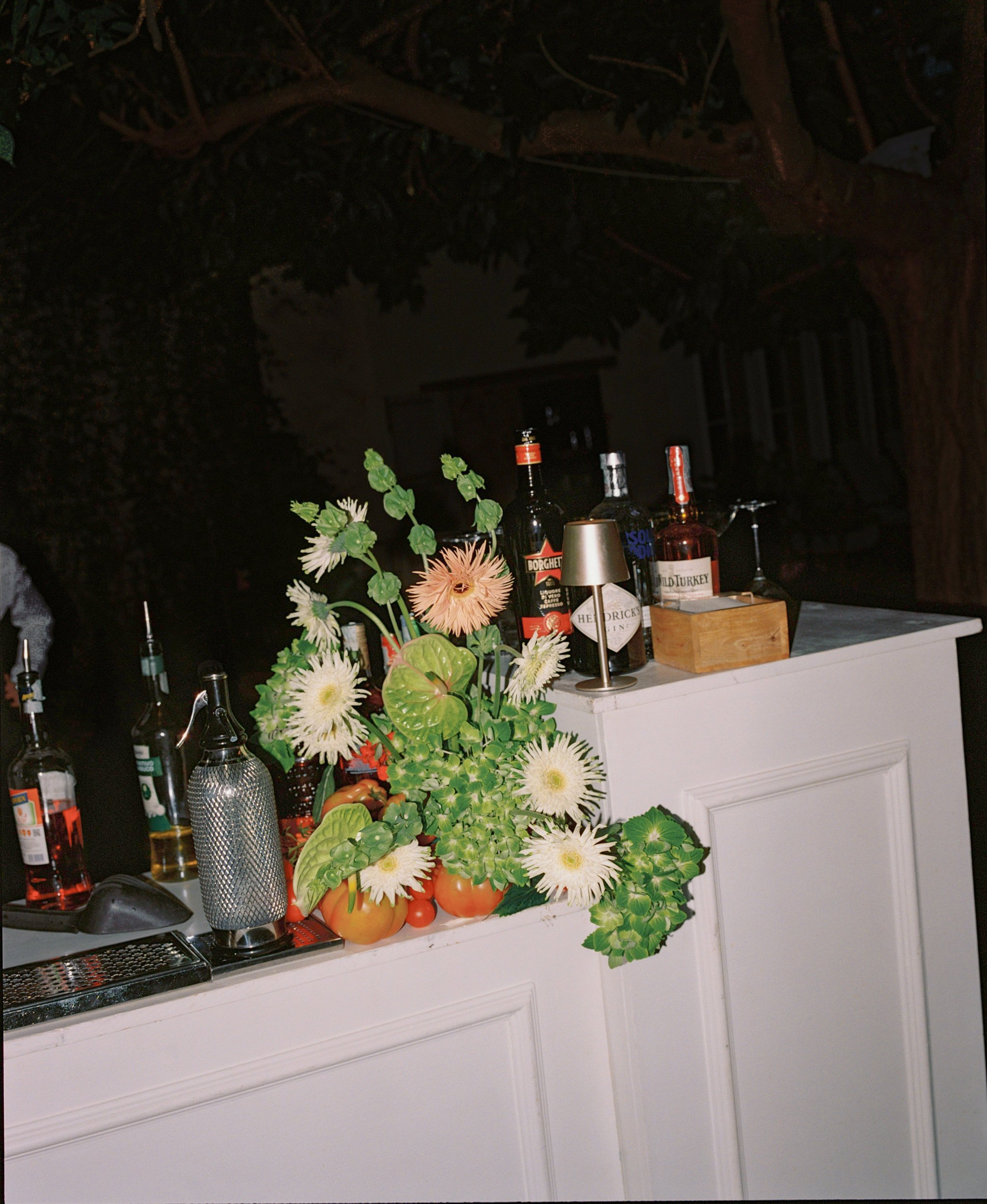 bar floral arrangement with tomatoes and anthurium at Vila Buonvisi in Tuscany