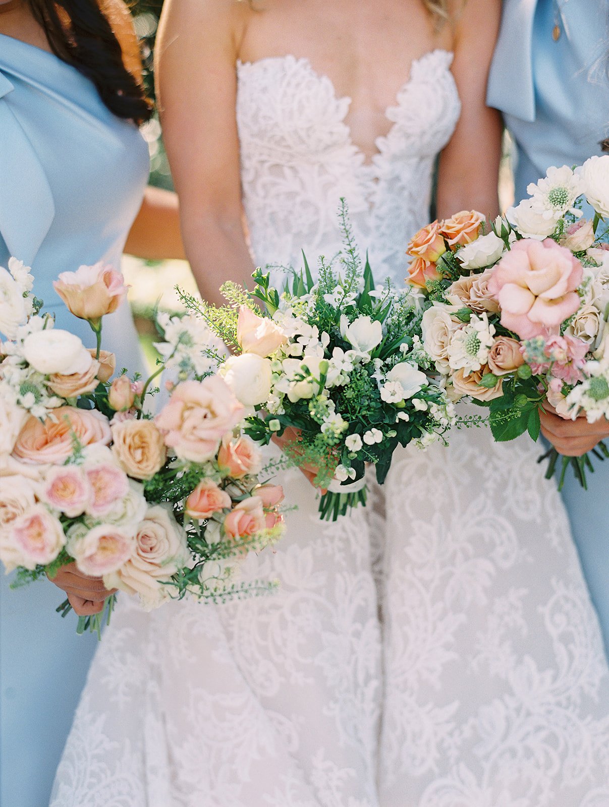 Bride and her bridesmaids with bouquets peaches and white flowers at Hotel Drover wedding